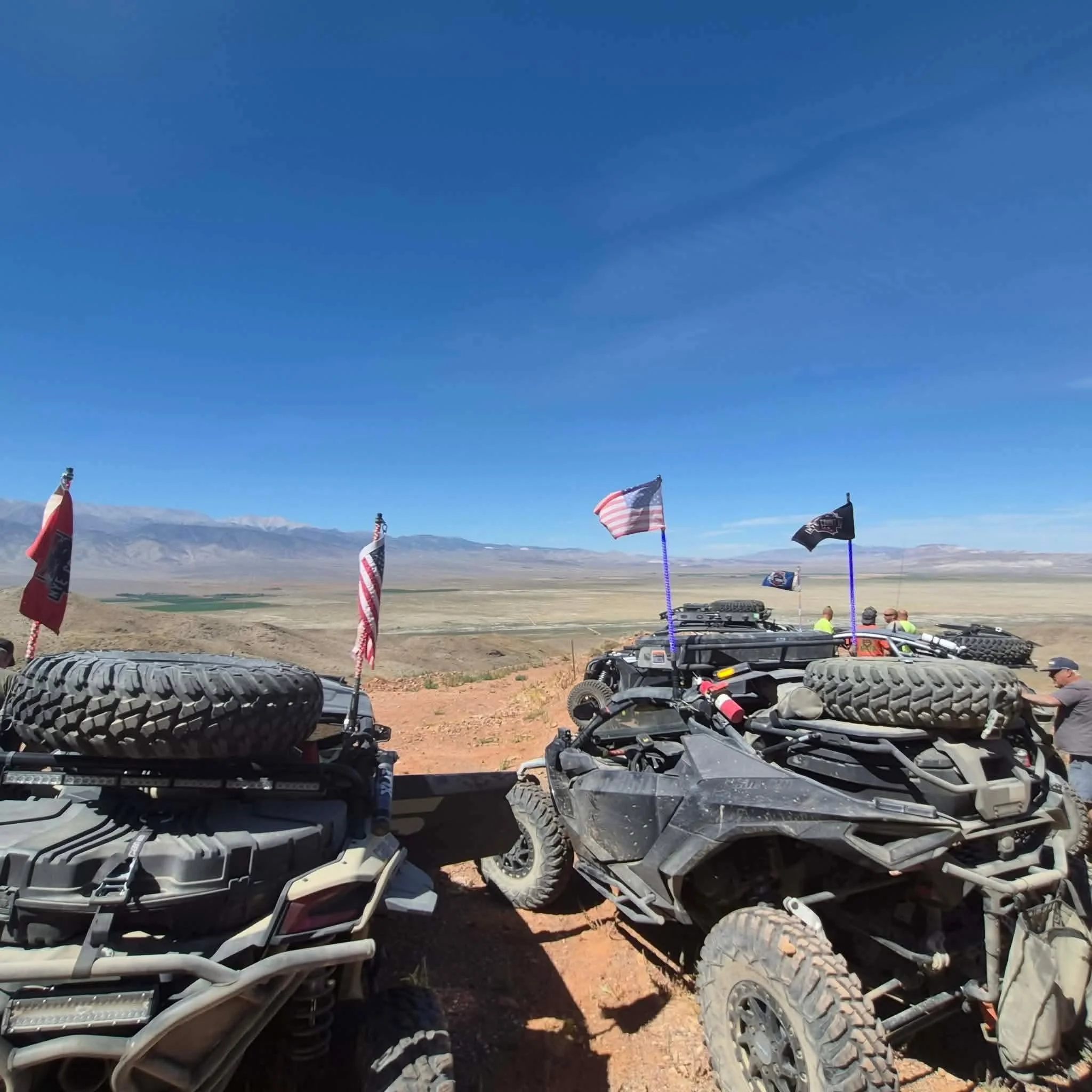 American and club flags flying atop UTVs overlooking Fish Lake Valley during the 2026 Dyer - Fish Lake Poker Run
