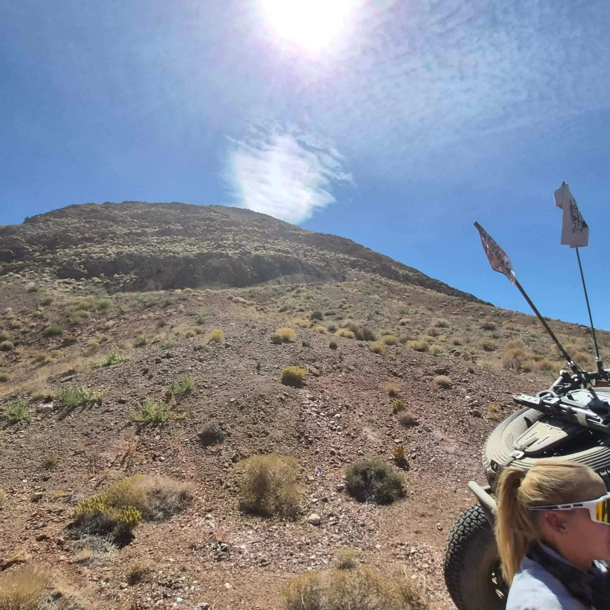 First-person view of a whip flag and desert hillside trail during the 2026 Dyer - Fish Lake Poker Run