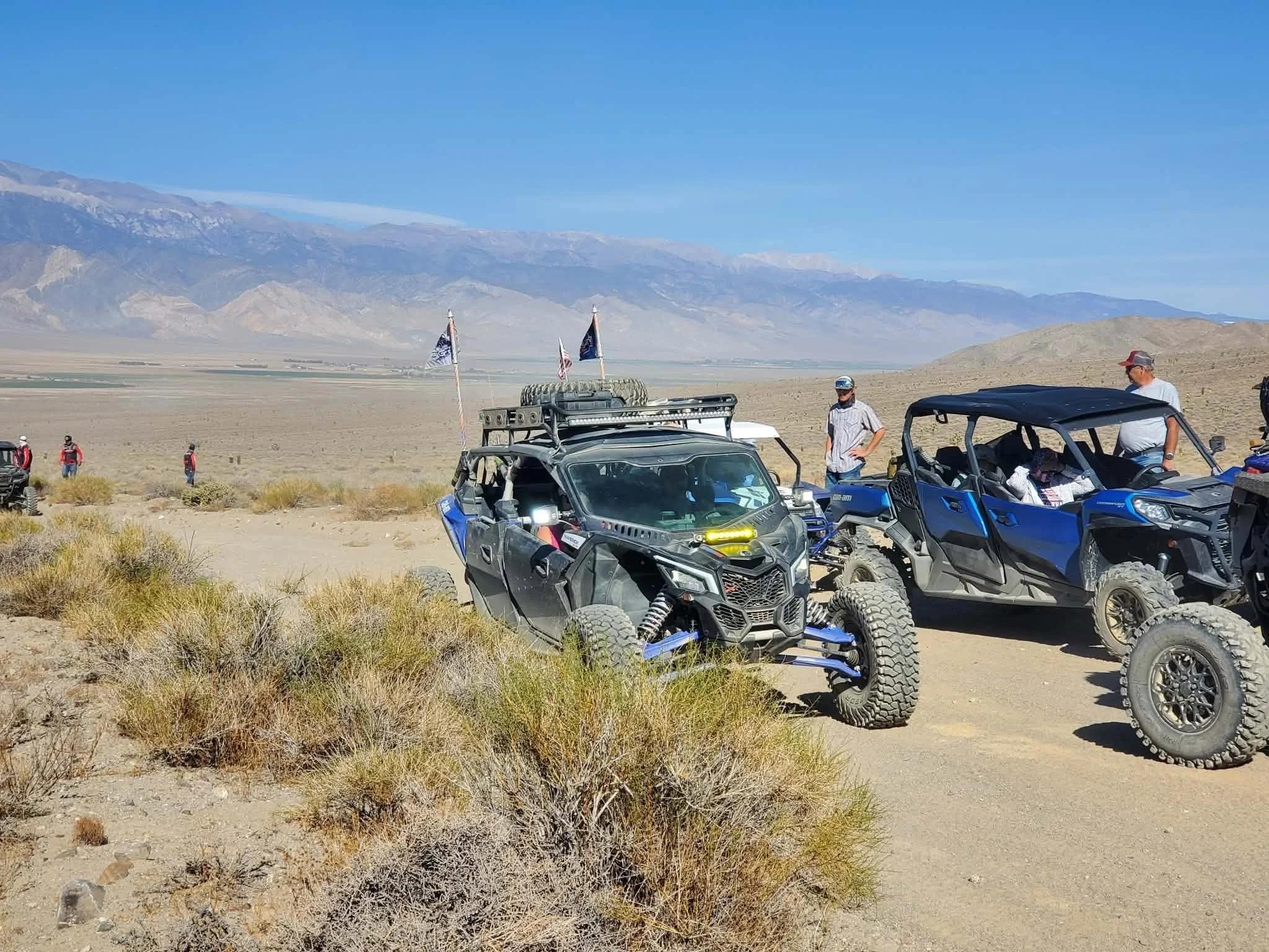 Two off-road UTVs traveling a desert trail overlooking Fish Lake Valley during the 2026 Dyer - Fish Lake Poker Run