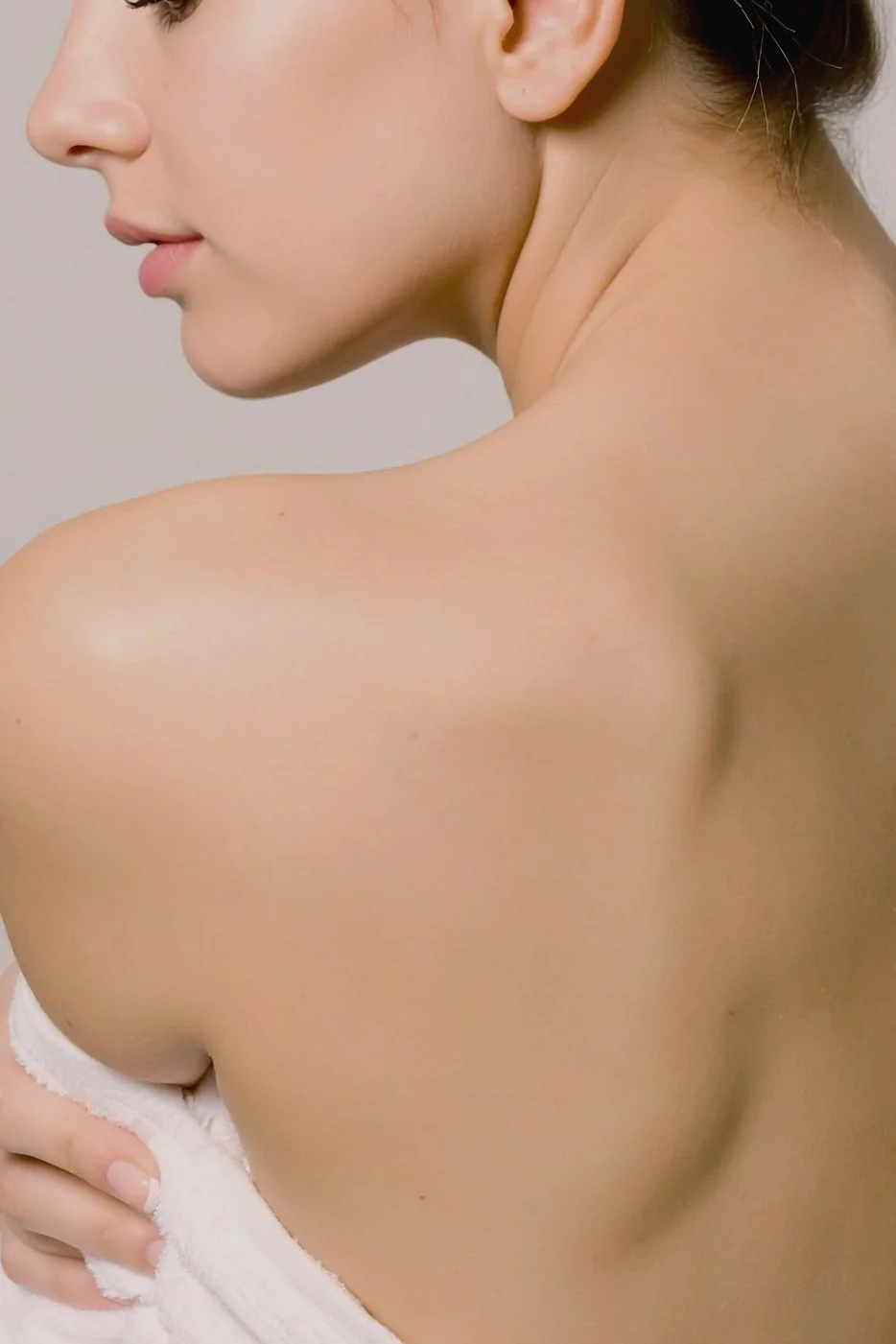 Over the shoulder of a woman's body, showing her skin.