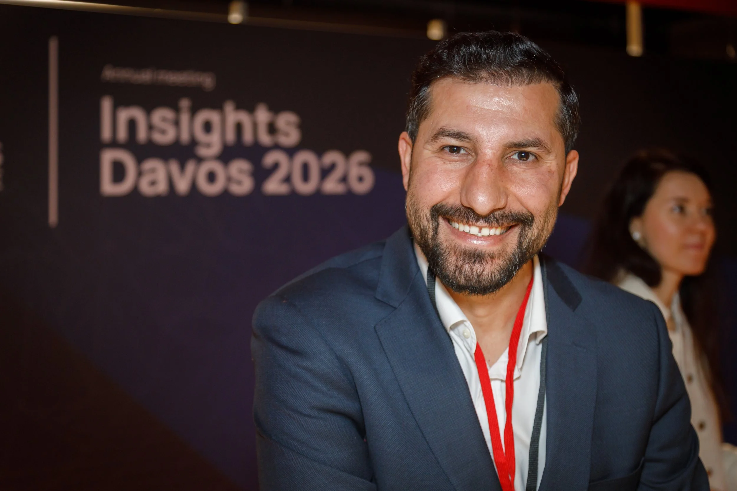 Professional headshot taken at a WEF Davos 2026 conference event.