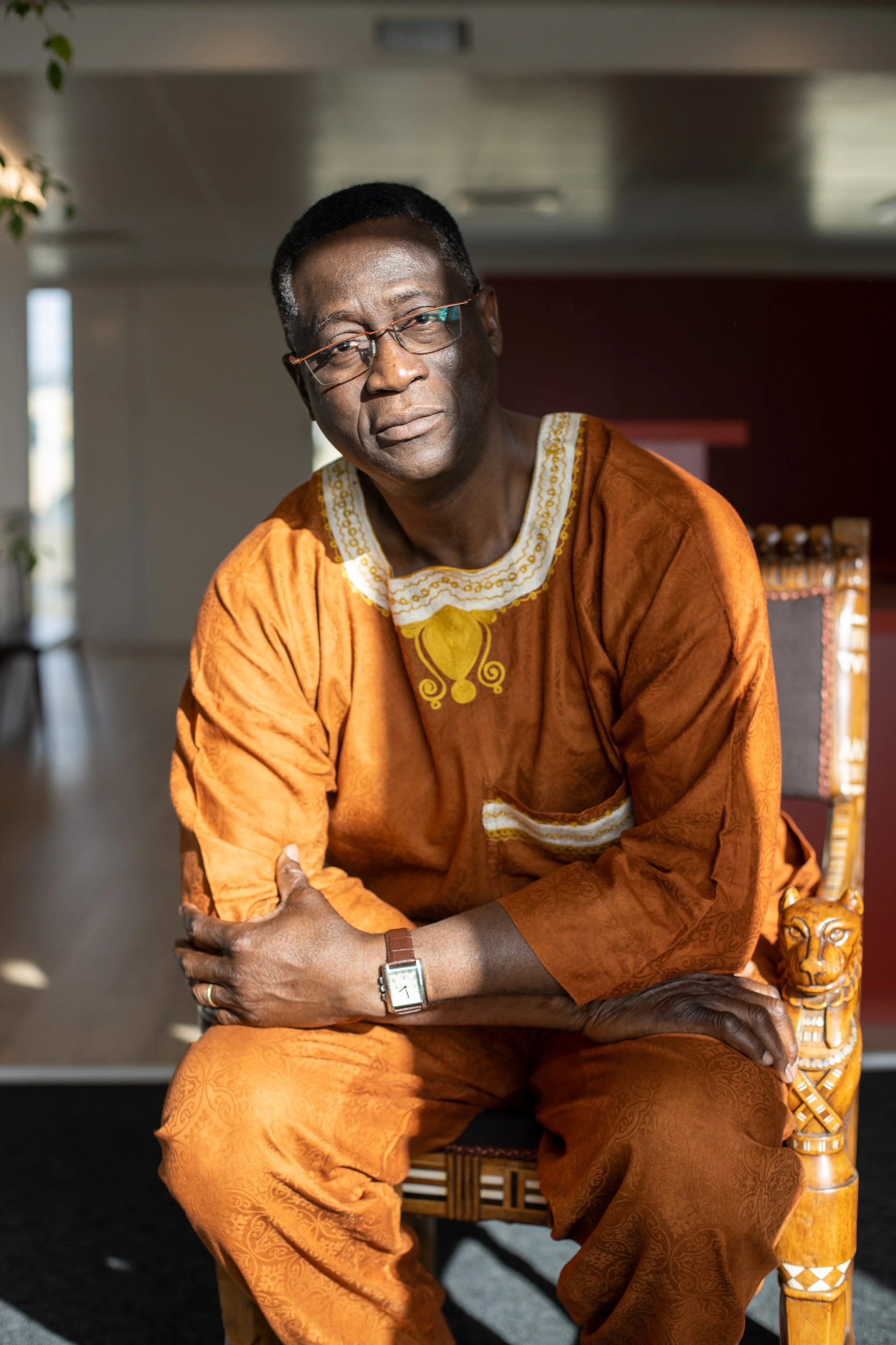 Portrait of a guest in traditional attire photographed at an event.