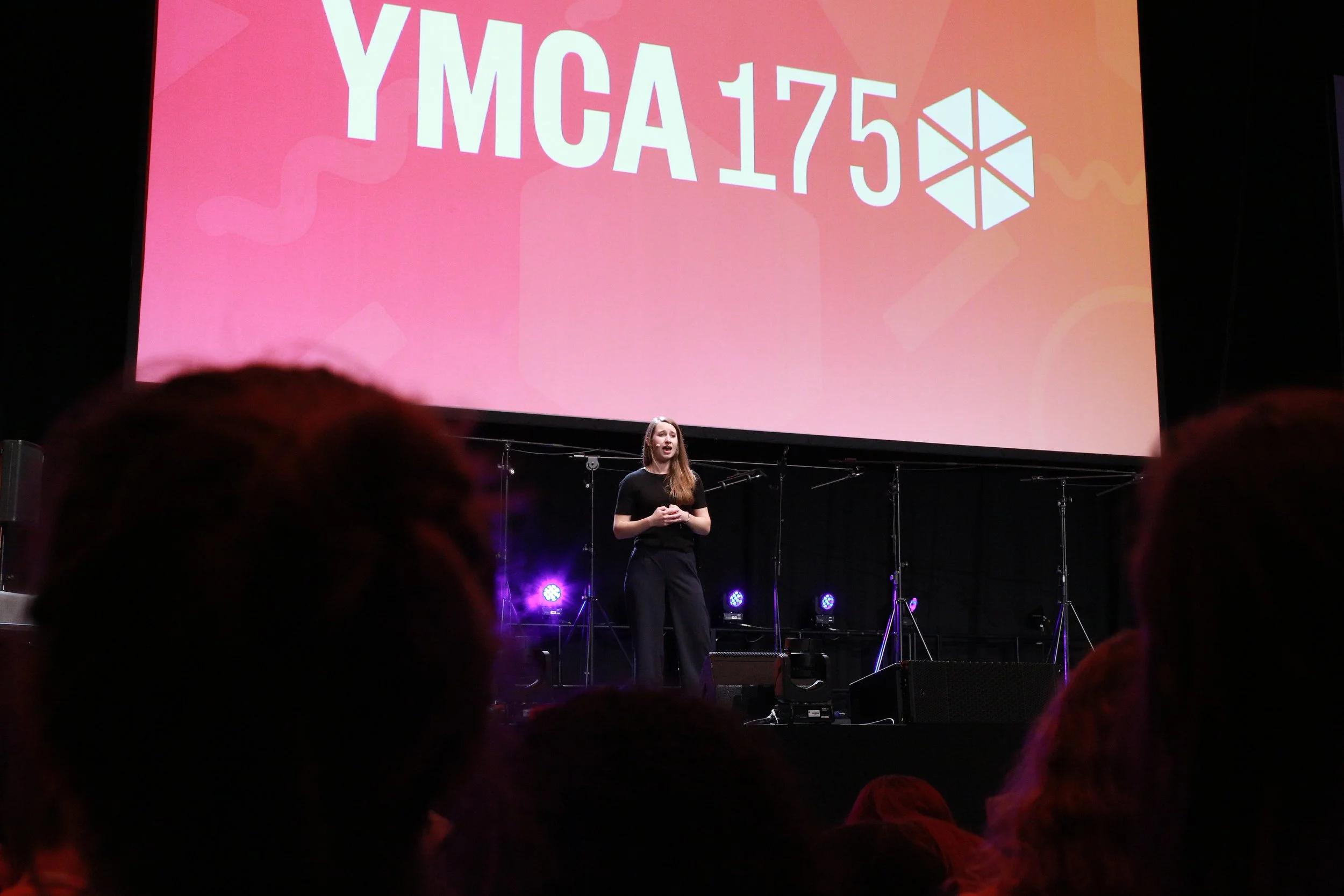 Keynote speaker on stage photographed during a live event.