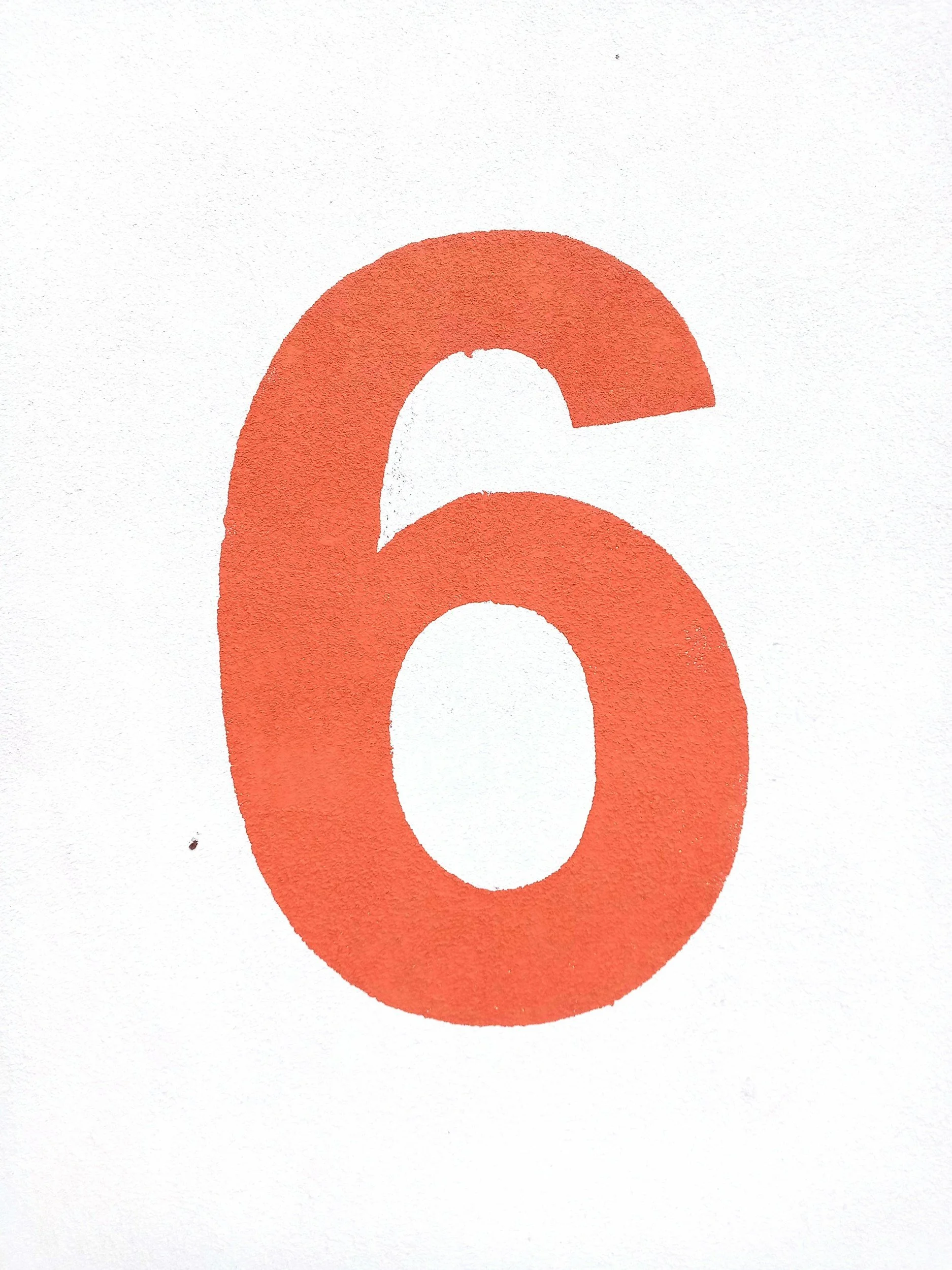 Red numeral six on a white background.
