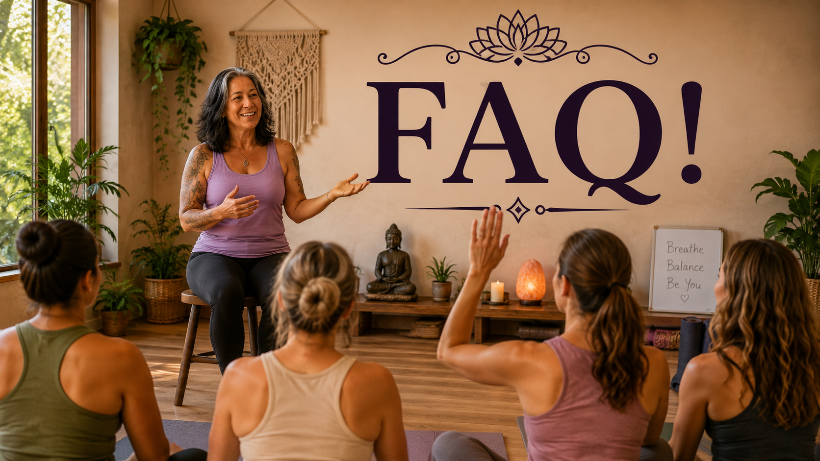 A woman leading a yoga or meditation class with four women seated on mats, one woman raising her hand, in a room with plants, candles, and a large wall art spelling 'FAQ!'.