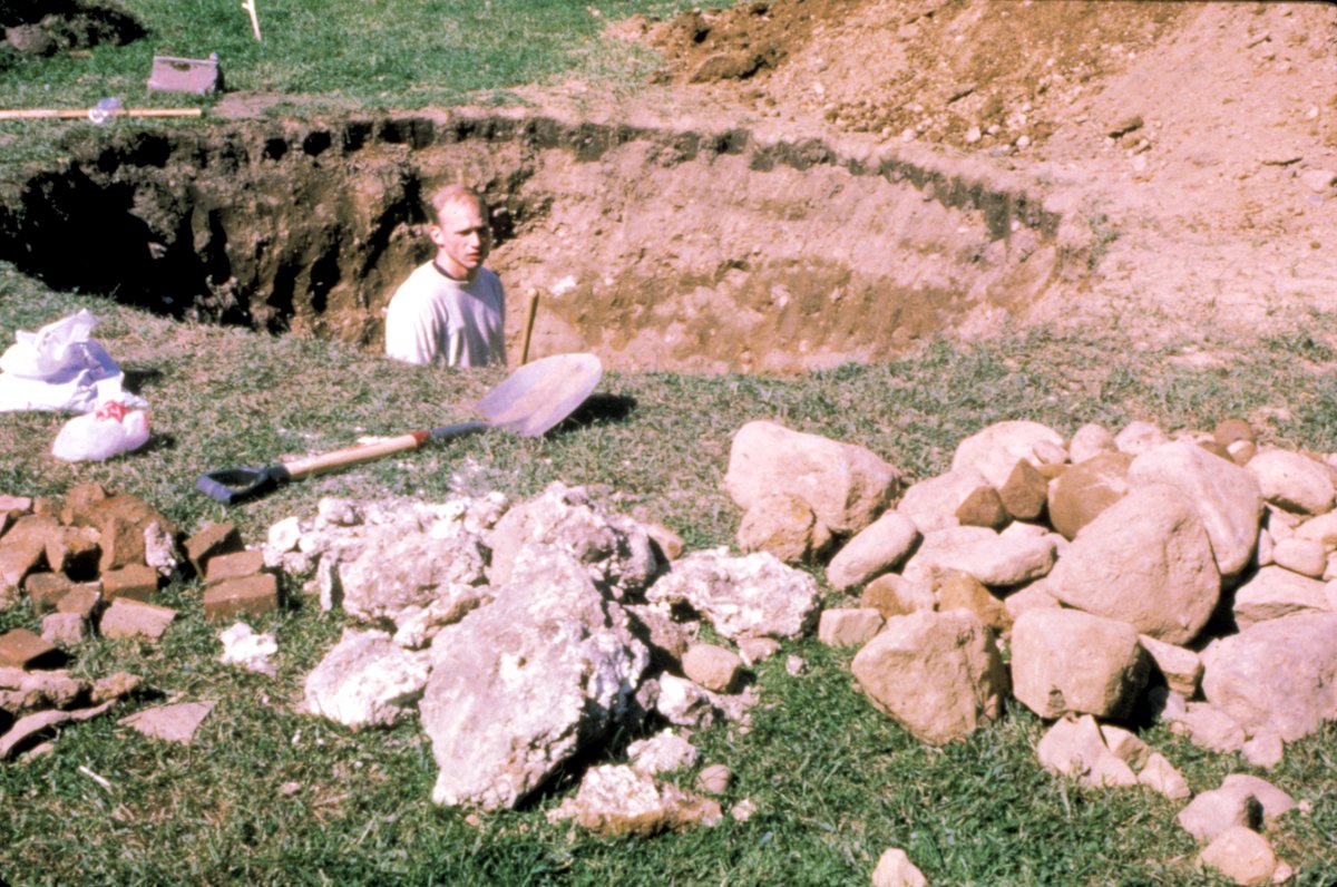 Samuel Nigro standing inside a large hand-dug excavation surrounded by removed stones and earth during a 24-hour digging action in 1996.