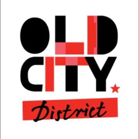 Graphic design with the words 'Old City District'; 'Old' and 'City' in black and red, 'District' written in black on a red background, with a small red star on the right.