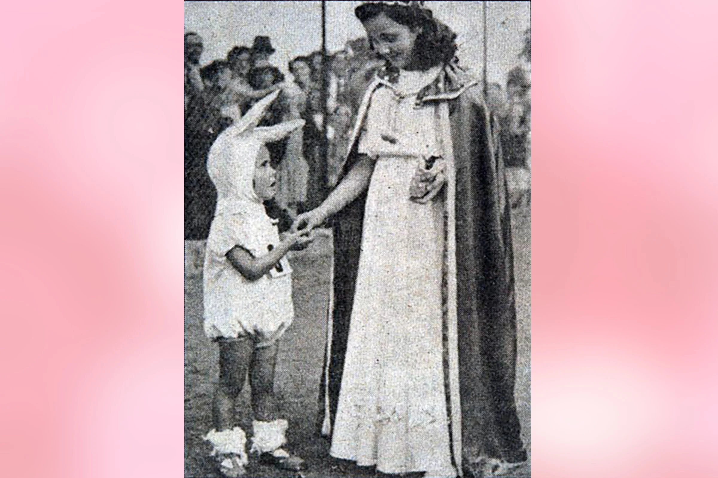  JENNIFER  handing out prizes at the children's carnival 1949
