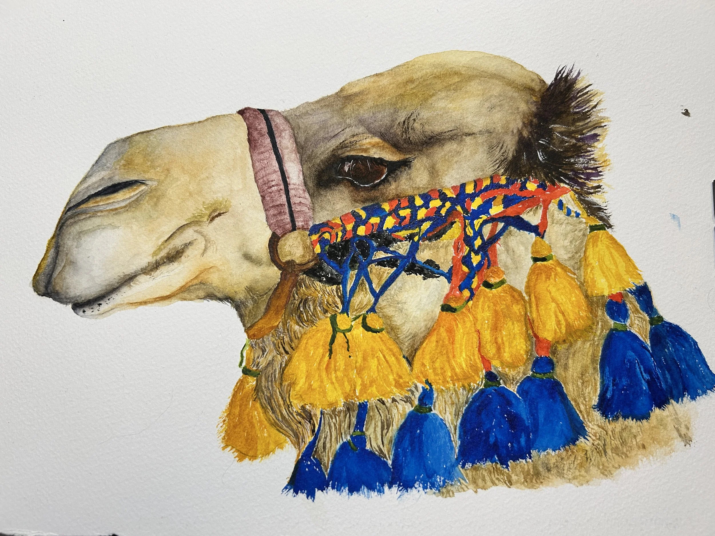Watercolor painting of a camel's head wearing a colorful necklace with yellow and blue tassels.