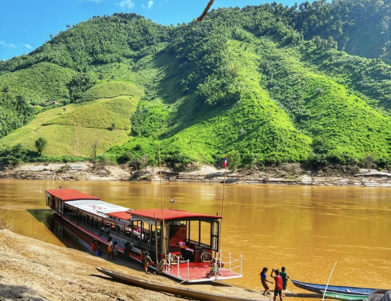 Mekong River landscape, traditional longtail boat, or riverside Northern Thailand village.