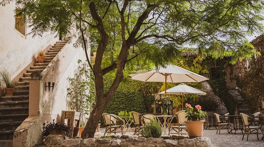 photo of Son Boronat, ideally the historic stone property with the pool, gardens, or surrounding landscape visible.