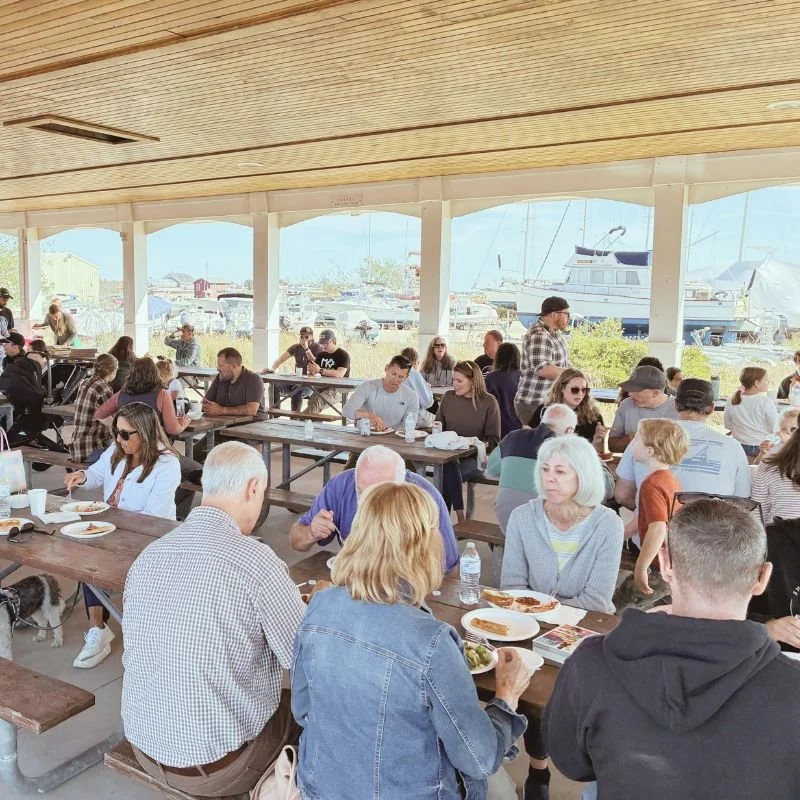 People dining at an outdoor Wells Harbor, after Shores Church service