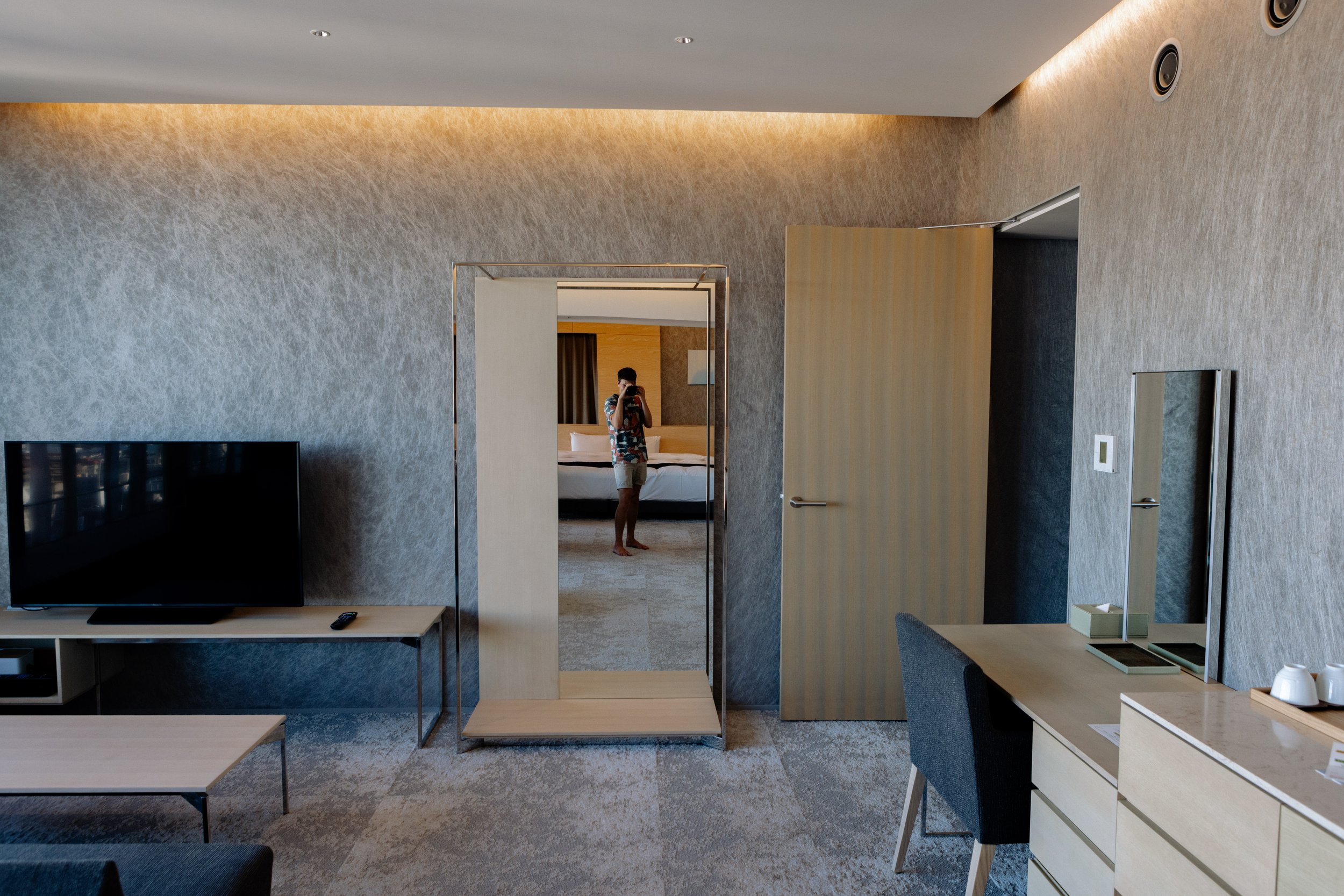 Man taking a photo in a hotel mirror