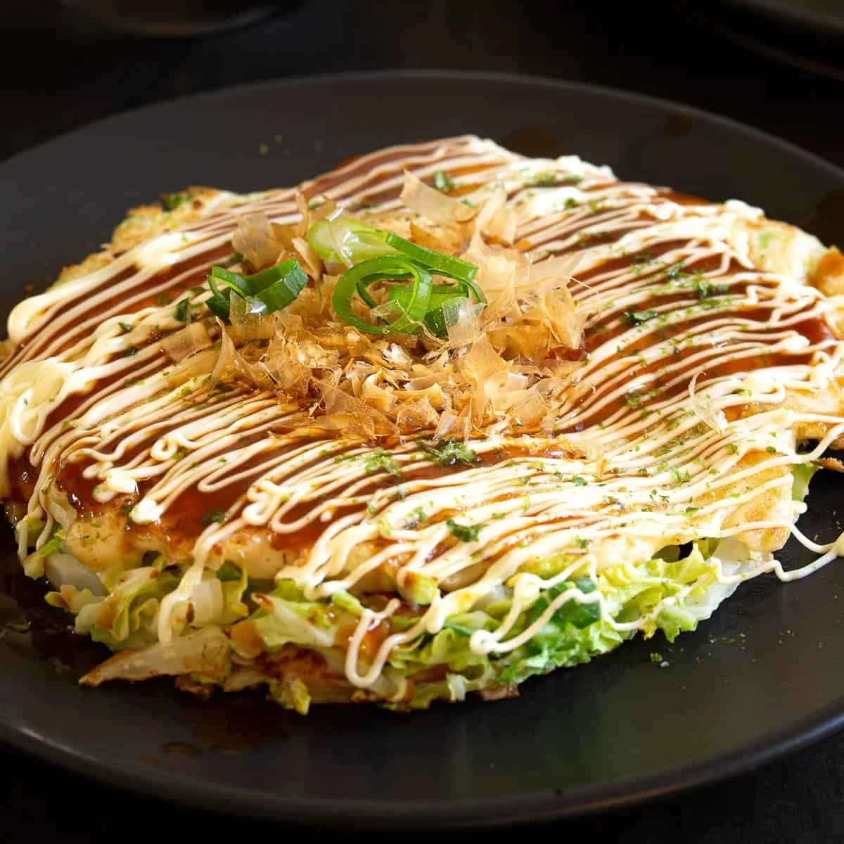 Okonomiyaki with bonito and green onion in Osaka Japan
