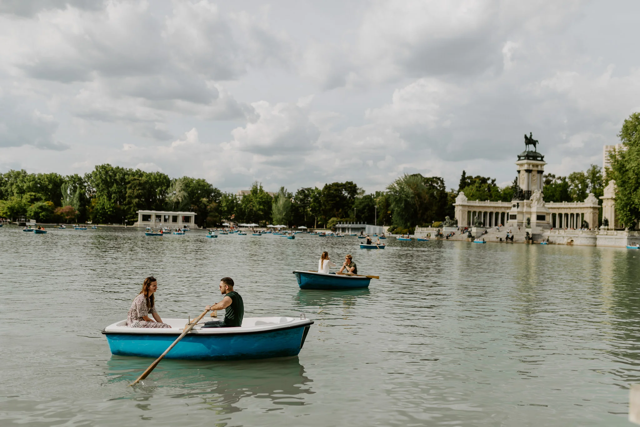People in a paddleboat on Retiro Park Lake