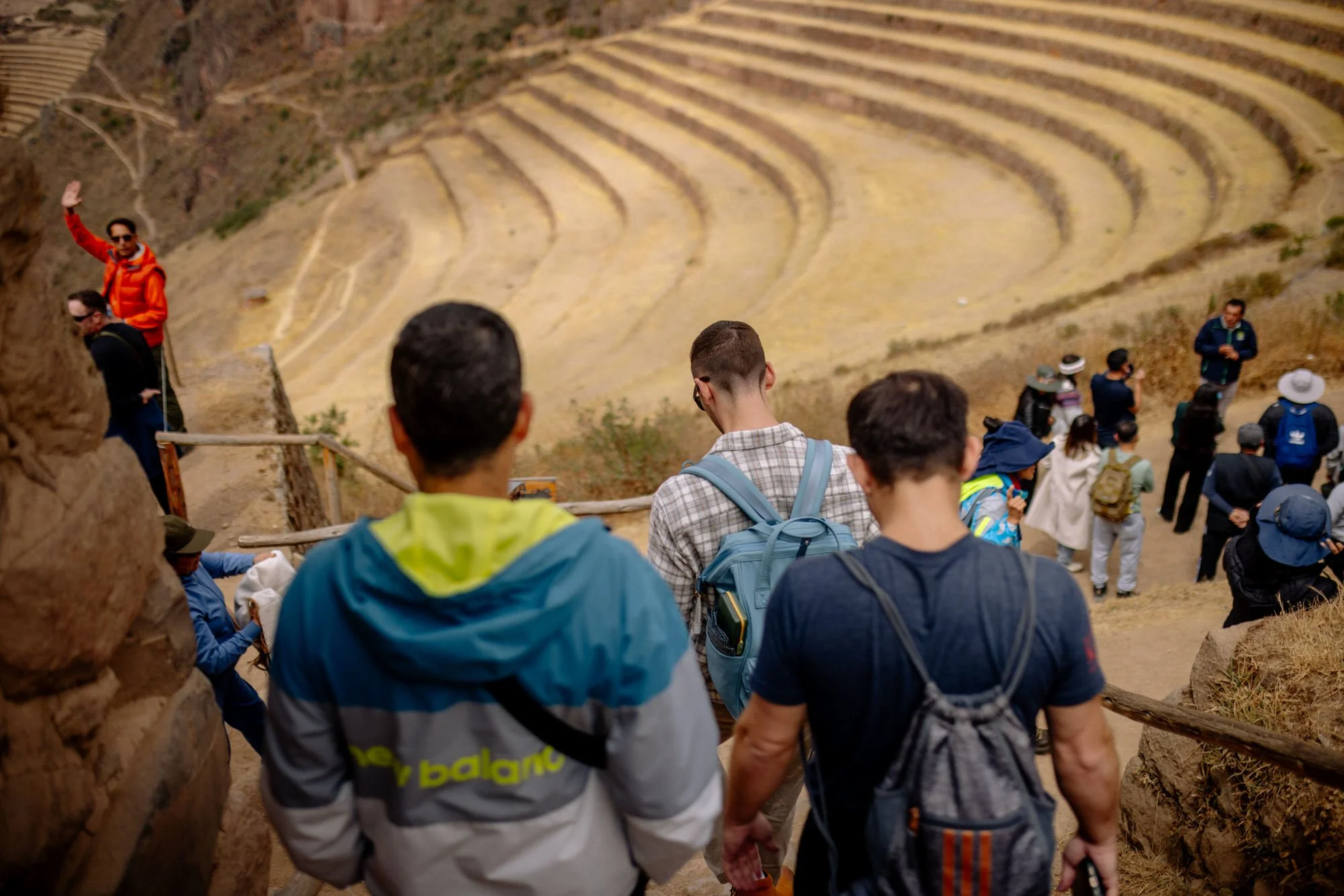 Tour group descending stone steps above the Inca agricultural terraces at Pisac in Peru's Sacred Valley.