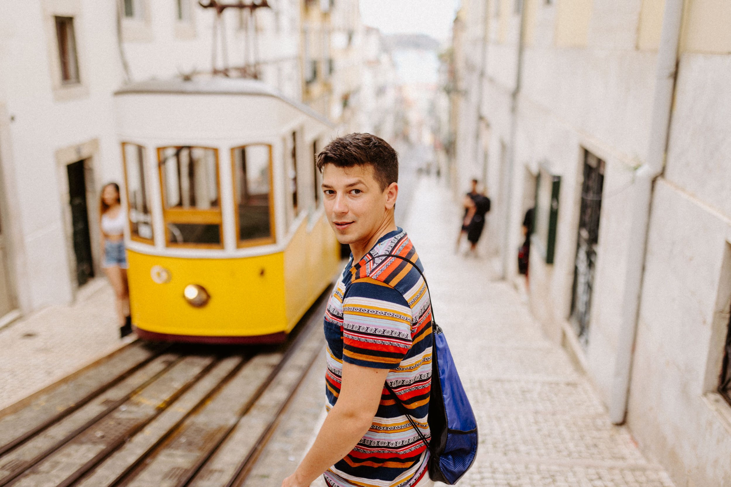 lisbon-yellow-tram-narrow-street-traveler.jpg