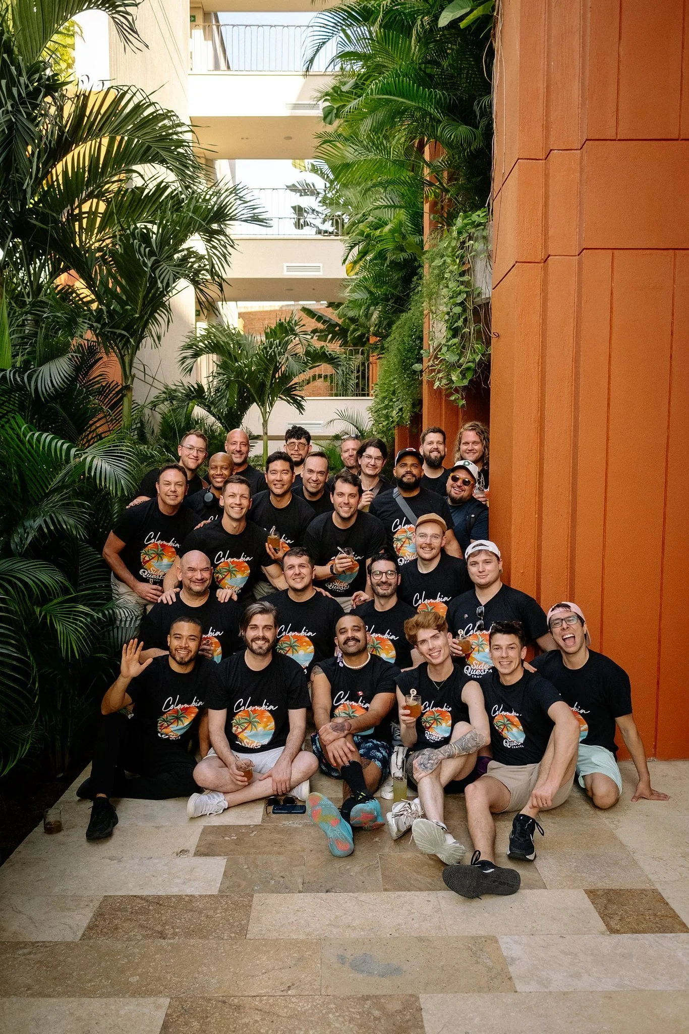 group in matching Colombia Side Quests Travel t-shirts posing together