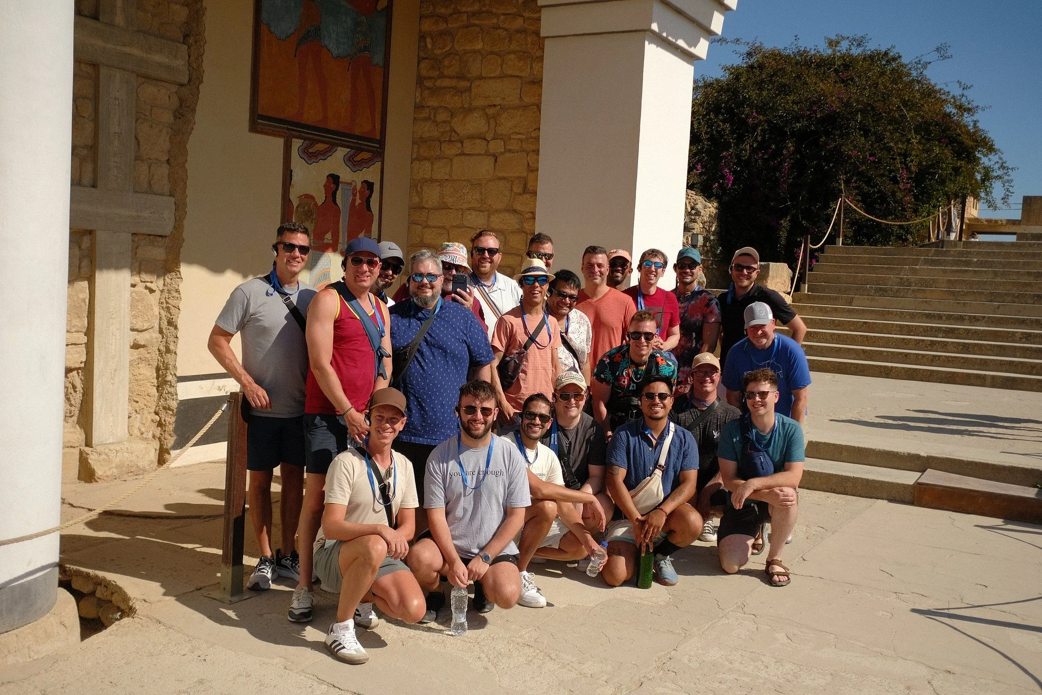 Group photo in front of ancient frescoes at the Palace of Knossos during a Crete retreat, Greece