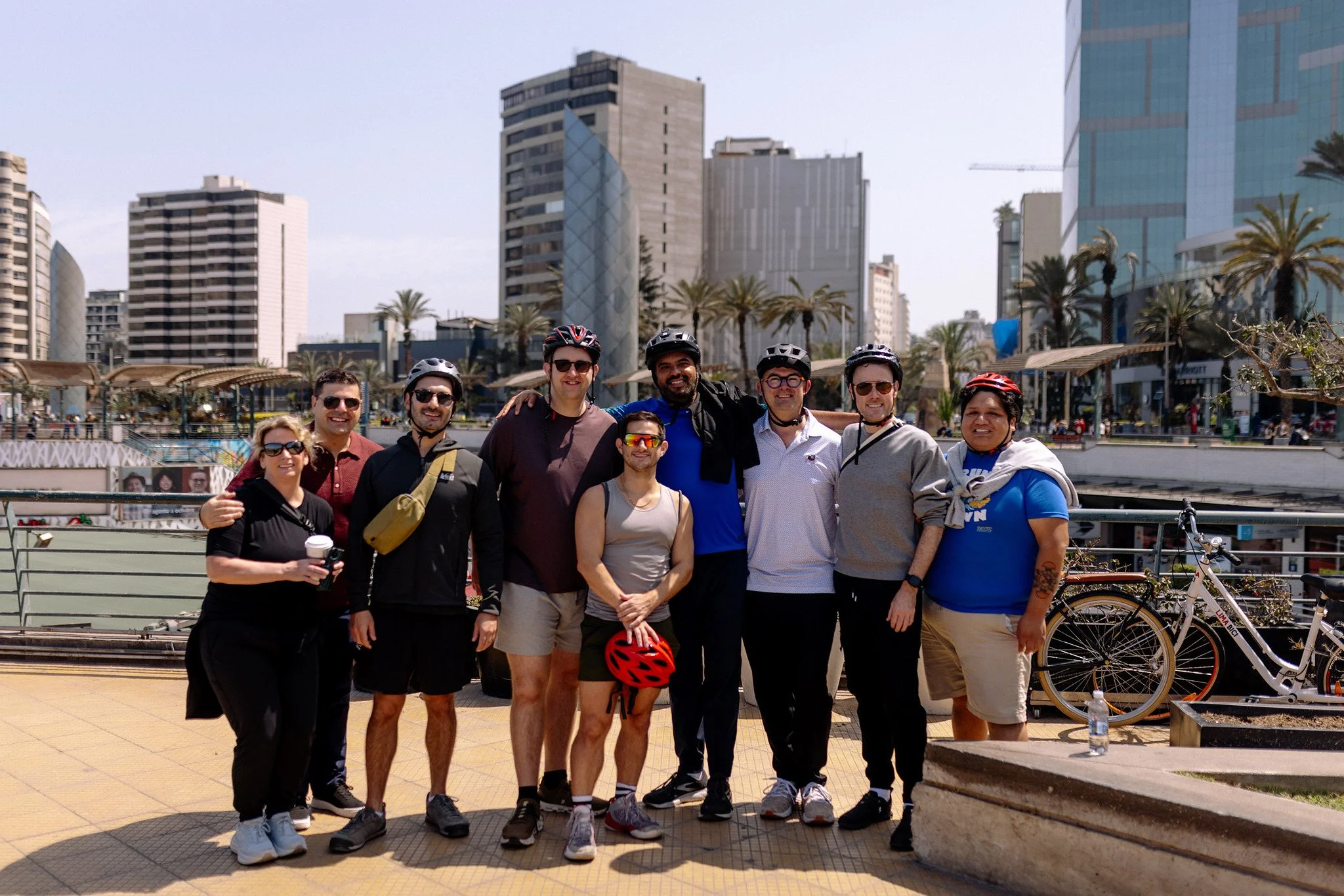 Group wearing helmets after a bike tour along the Malecón in Miraflores, Lima