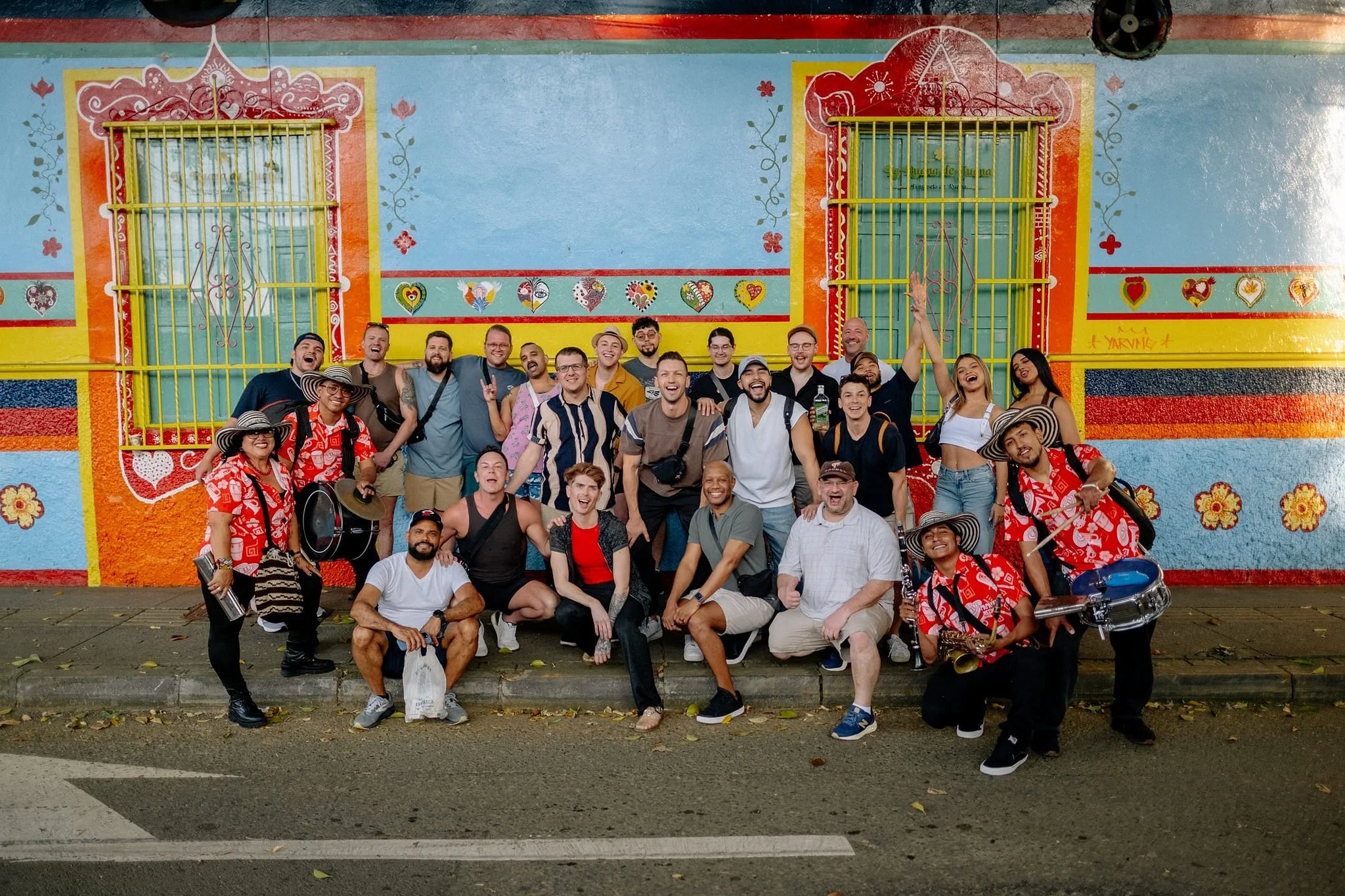 SideQuests Travel Group posing with local folk band in Comuna 13, Medellín