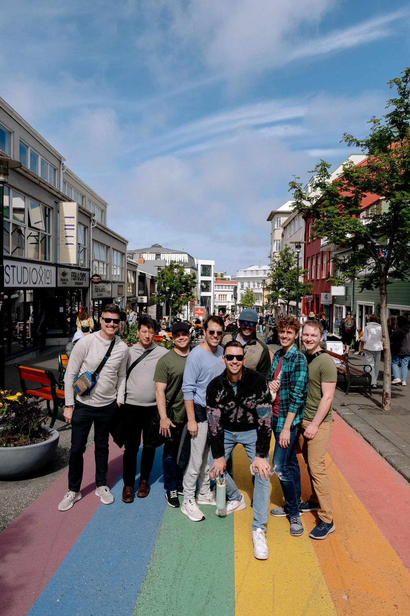 Travel group standing on Reykjavík's iconic rainbow-painted street, Skólavörðustígur, Iceland