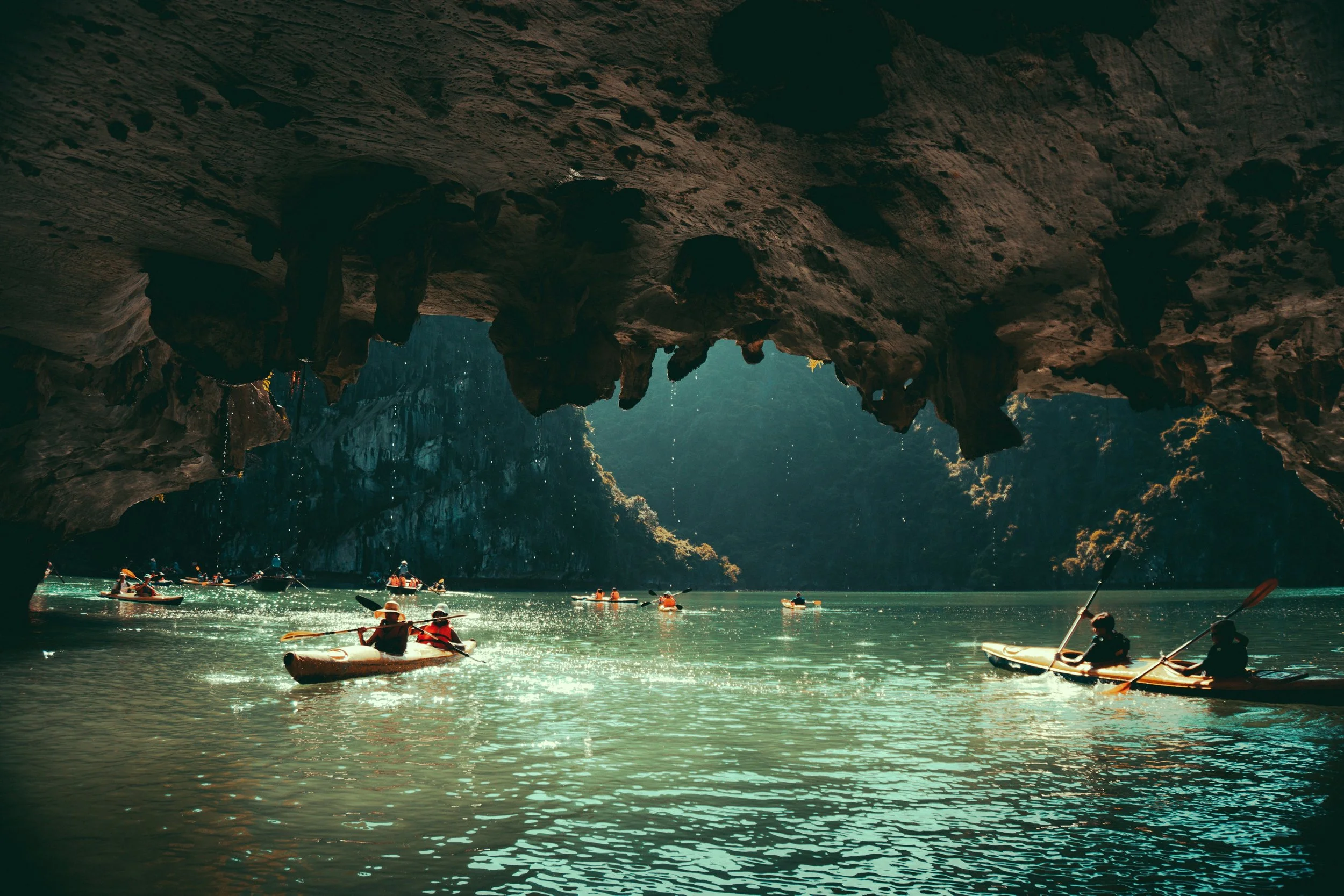 Kayaking through sea caves in Ha Long Bay.
