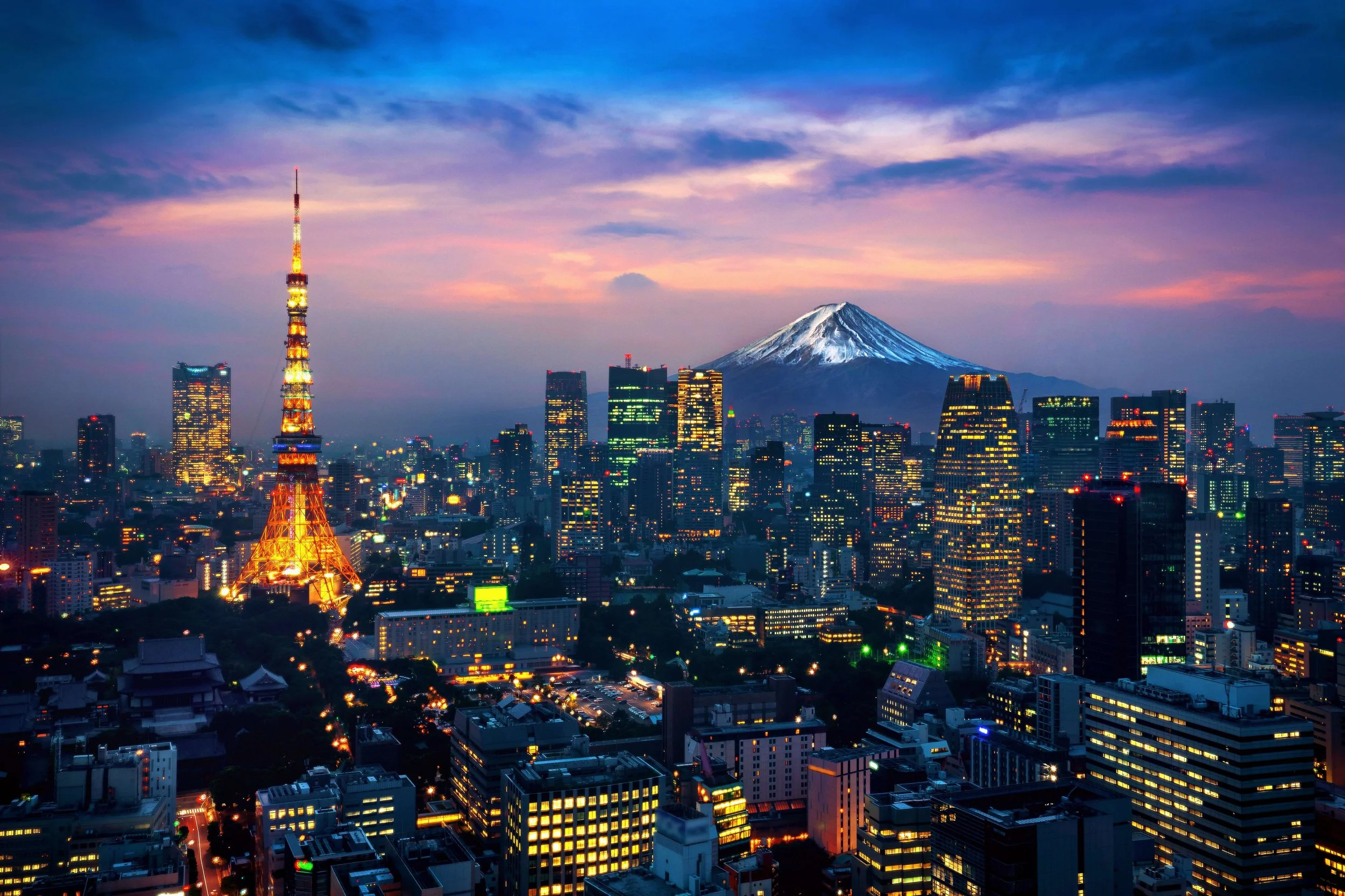 Tokyo Tower illuminated at sunset with Mt. Fuji behind the city skyline — where to stay in Tokyo for LGBTQ+ traveler