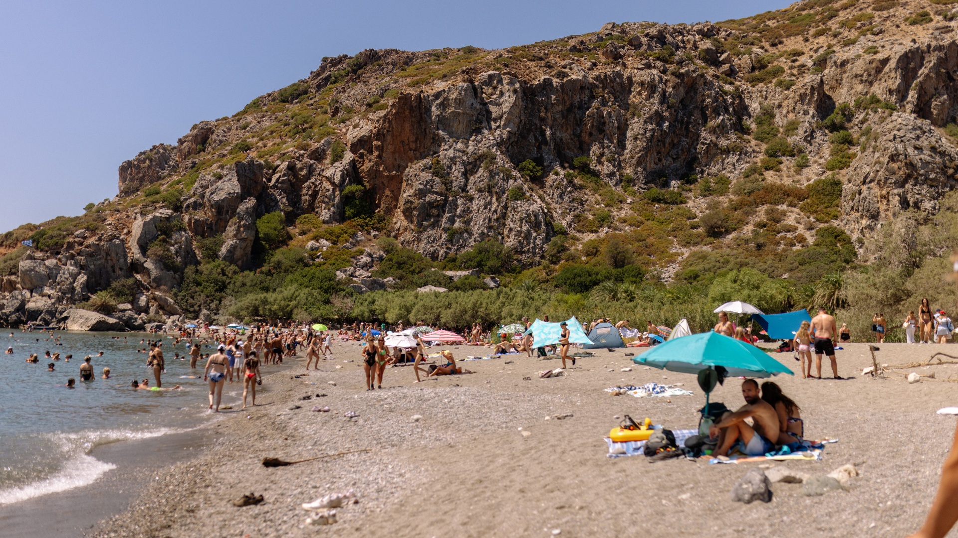 Albanian beach with umbrellas and people