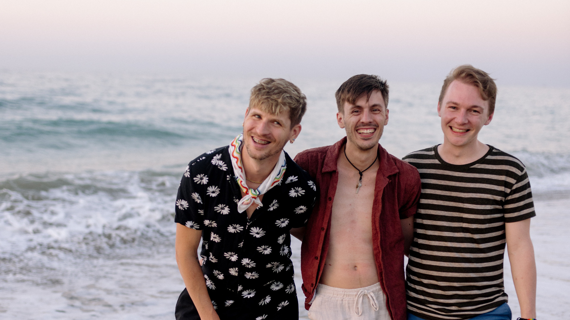 3 men at an Albanian beach smiling