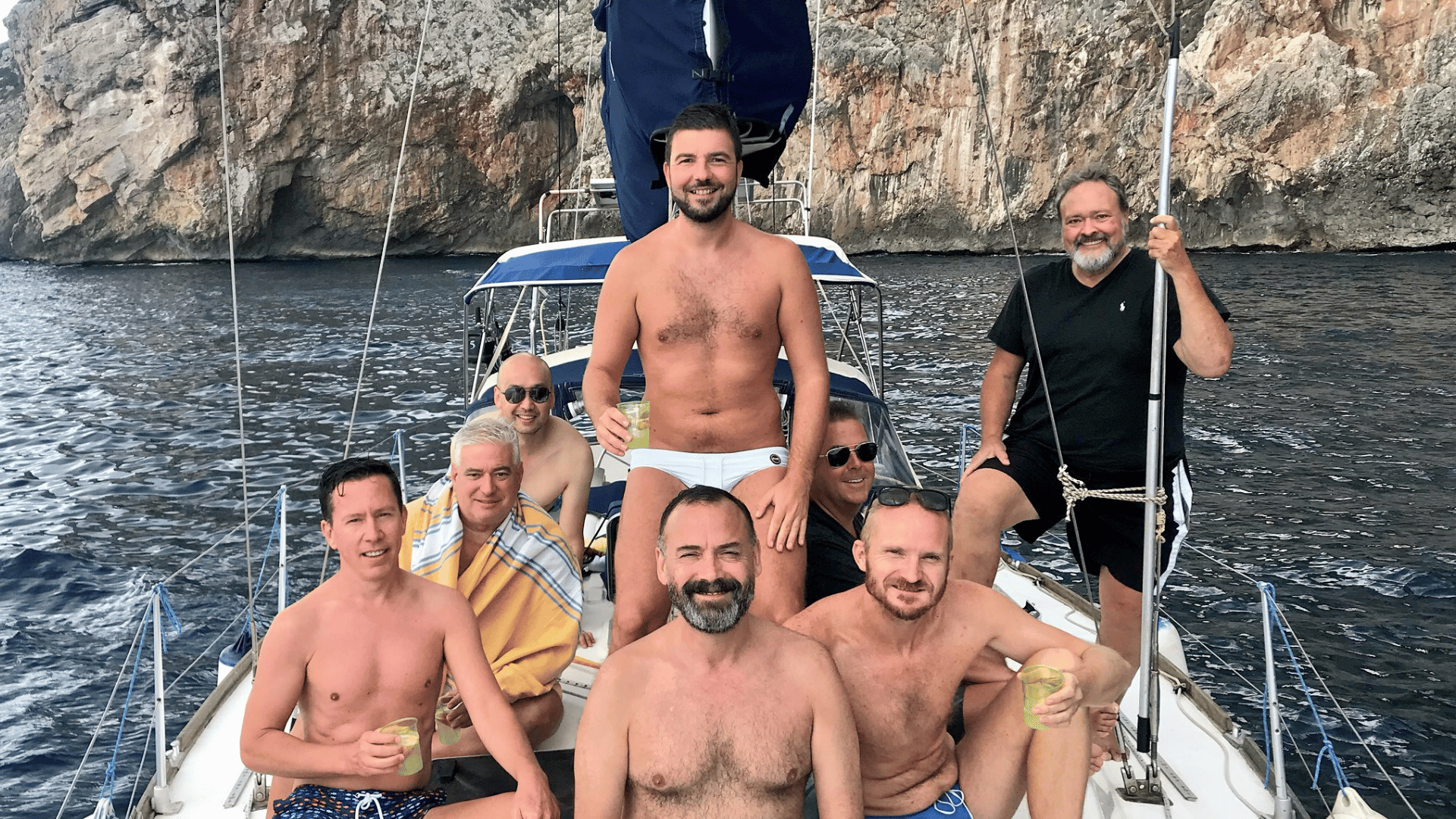 Dudes on a boat in the ocean with wine