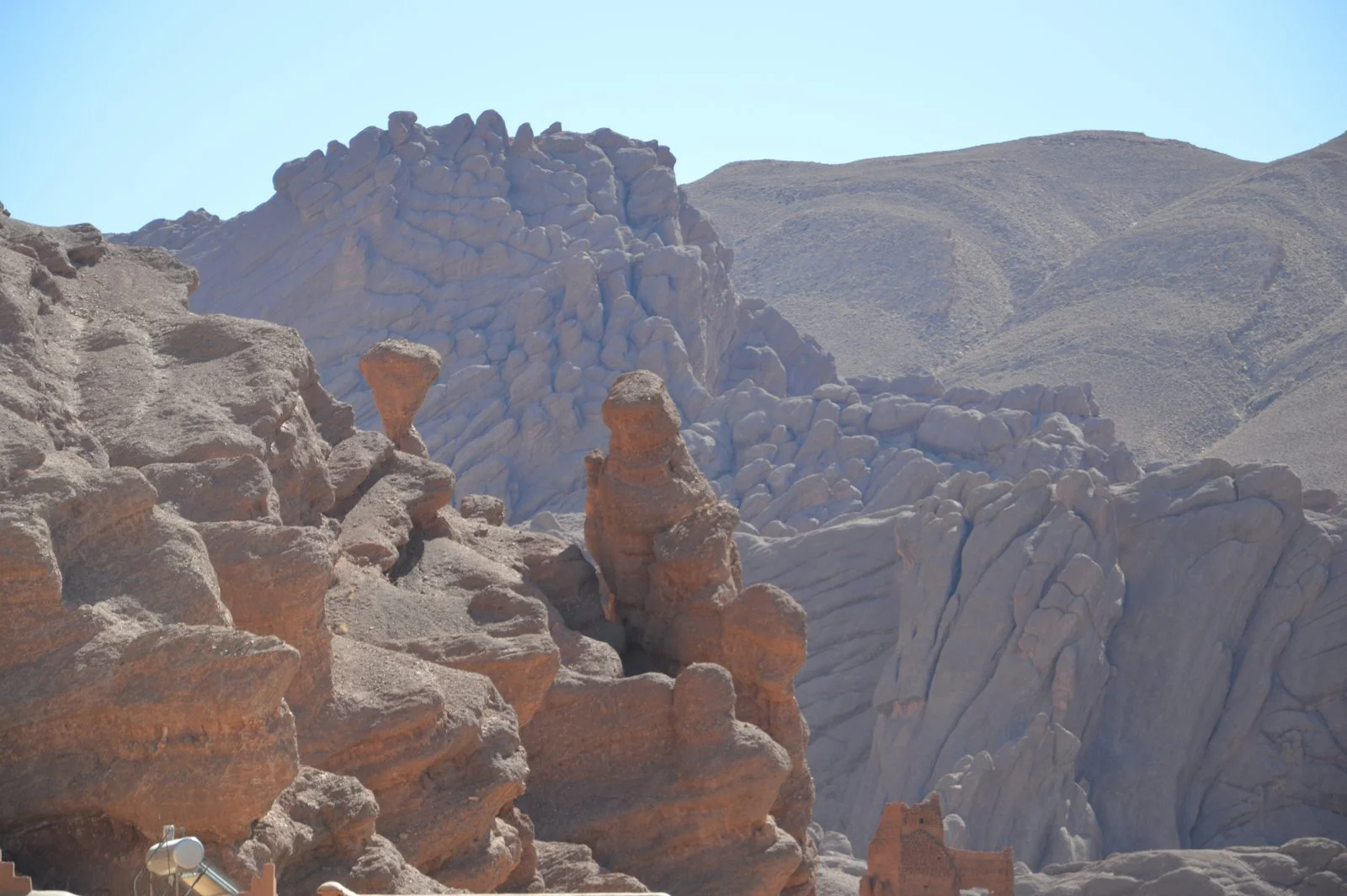 Red canyon walls and the Monkey Fingers rock formations in Morocco's Dadès Valley