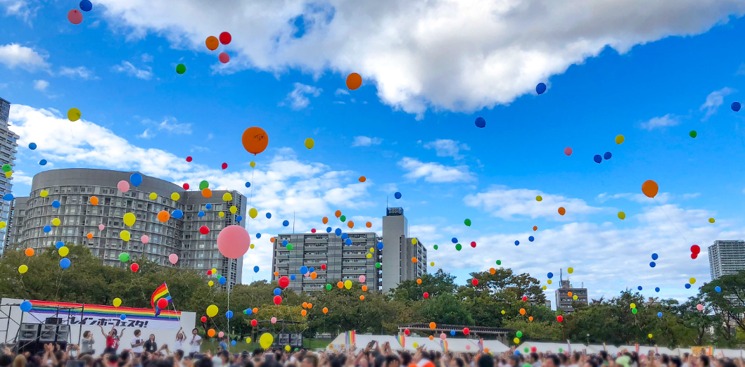 Balloons floating in the sky at a pride parade in Osaka