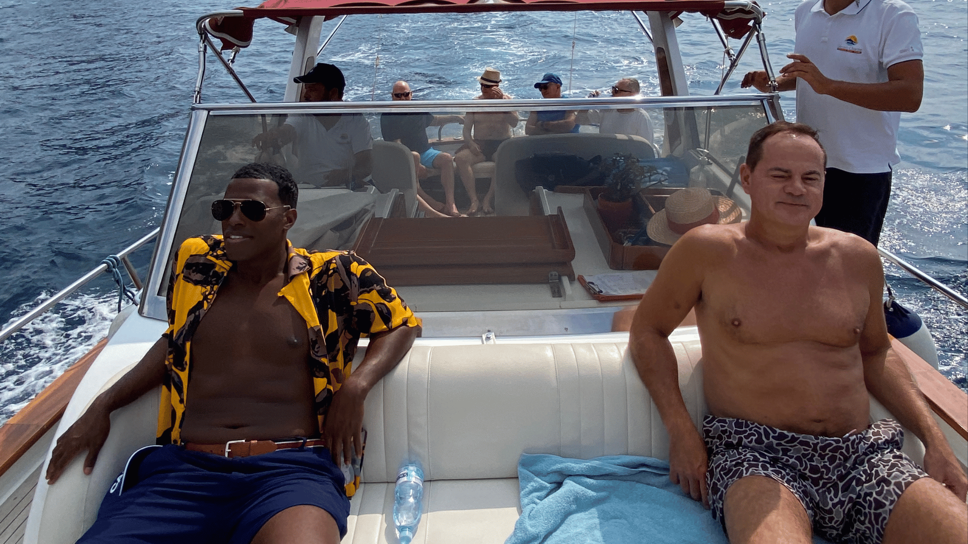 Two men lounging on a speedboat
