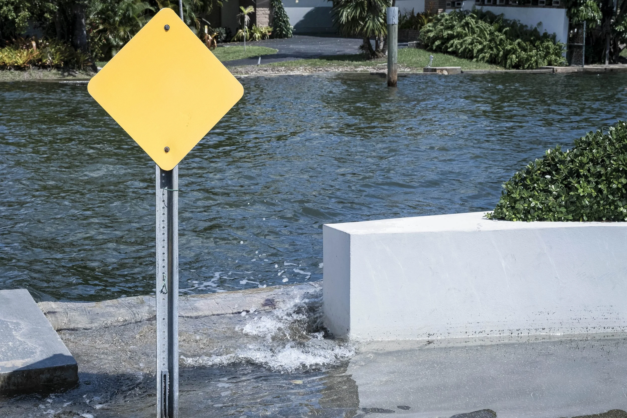 King Tide Flooding Covers Street, Yellow Sign, Canal Breach, Miami, 2024. Rana A Fine.