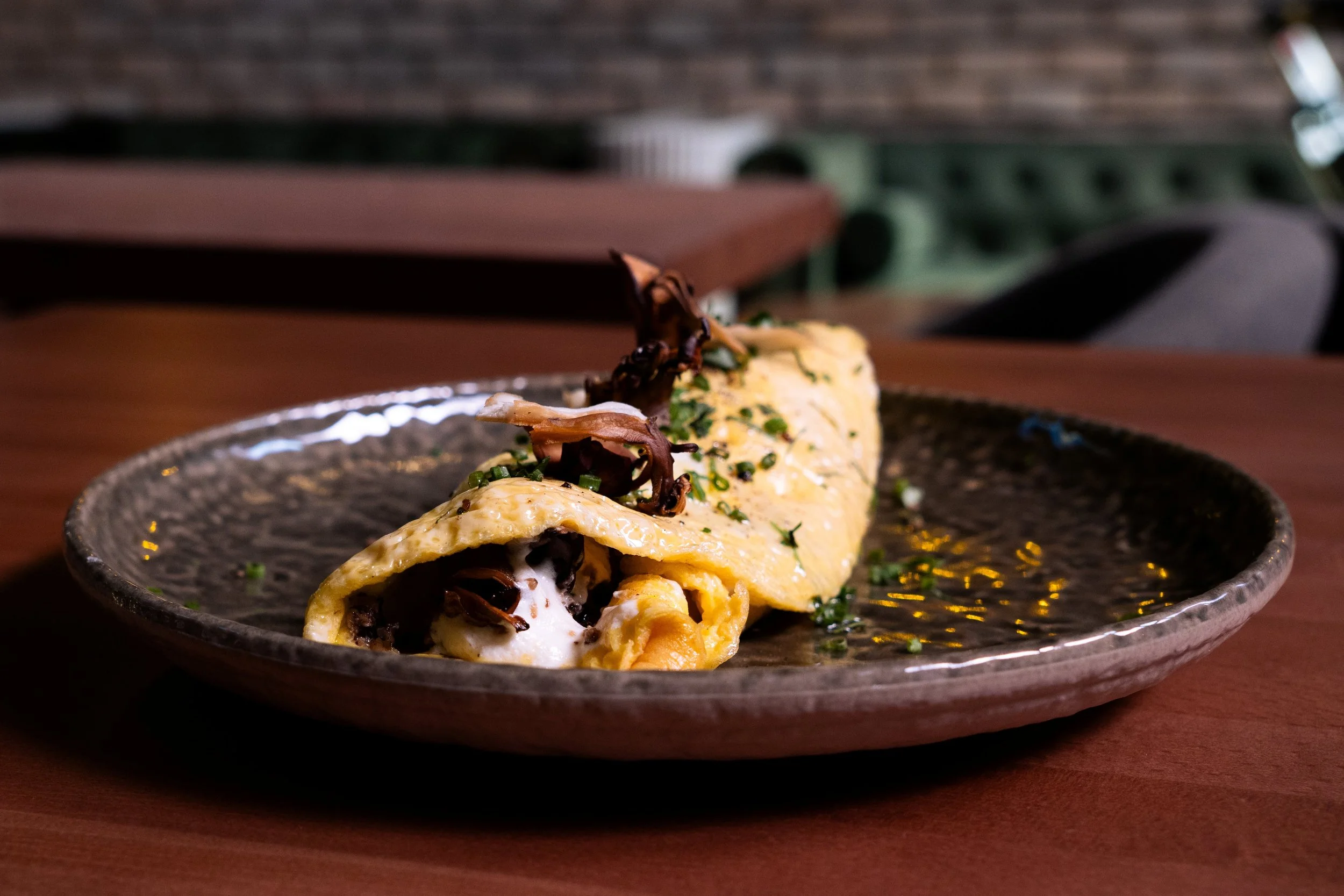 Gunny’s brunch mushroom omelet layers roasted mushrooms, savory mushroom XO and whipped goat cheese inside tender eggs. A rich, vegetable-forward brunch dish from our Lincoln Park neighborhood restaurant.