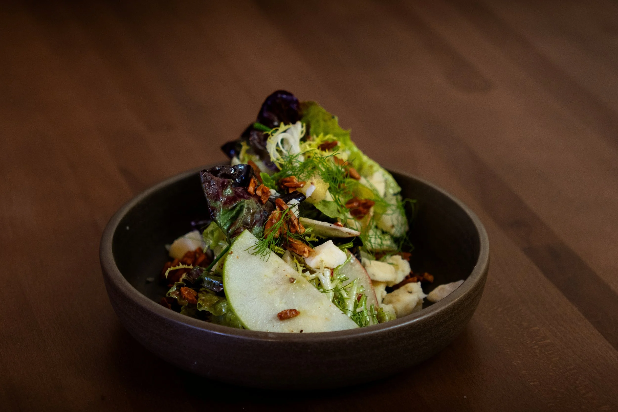 Market Days at Gunny’s Pub, a seasonal Midwestern salad built with bitter greens, Prairie Breeze cheddar, roasted almonds and champagne mustard vinaigrette, with crisp green apple. Fresh, bright and very much driven by what’s good right now.