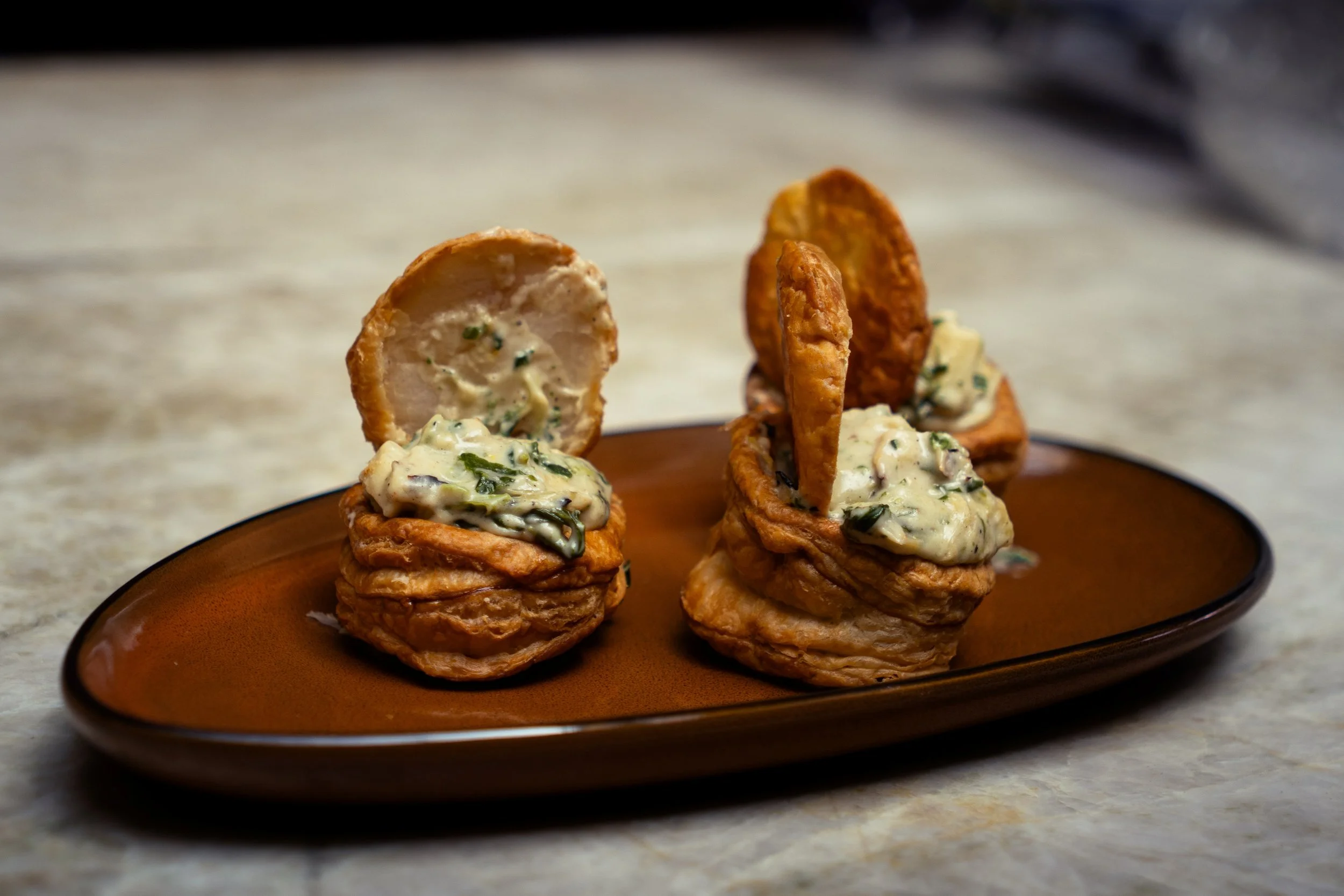 Gunny’s Bar Pies are flaky little puff-pastry pies filled with spinach, artichoke and hearts of palm and finished with crispy onions. A very Gunny’s version of familiar spinach-artichoke comfort food.