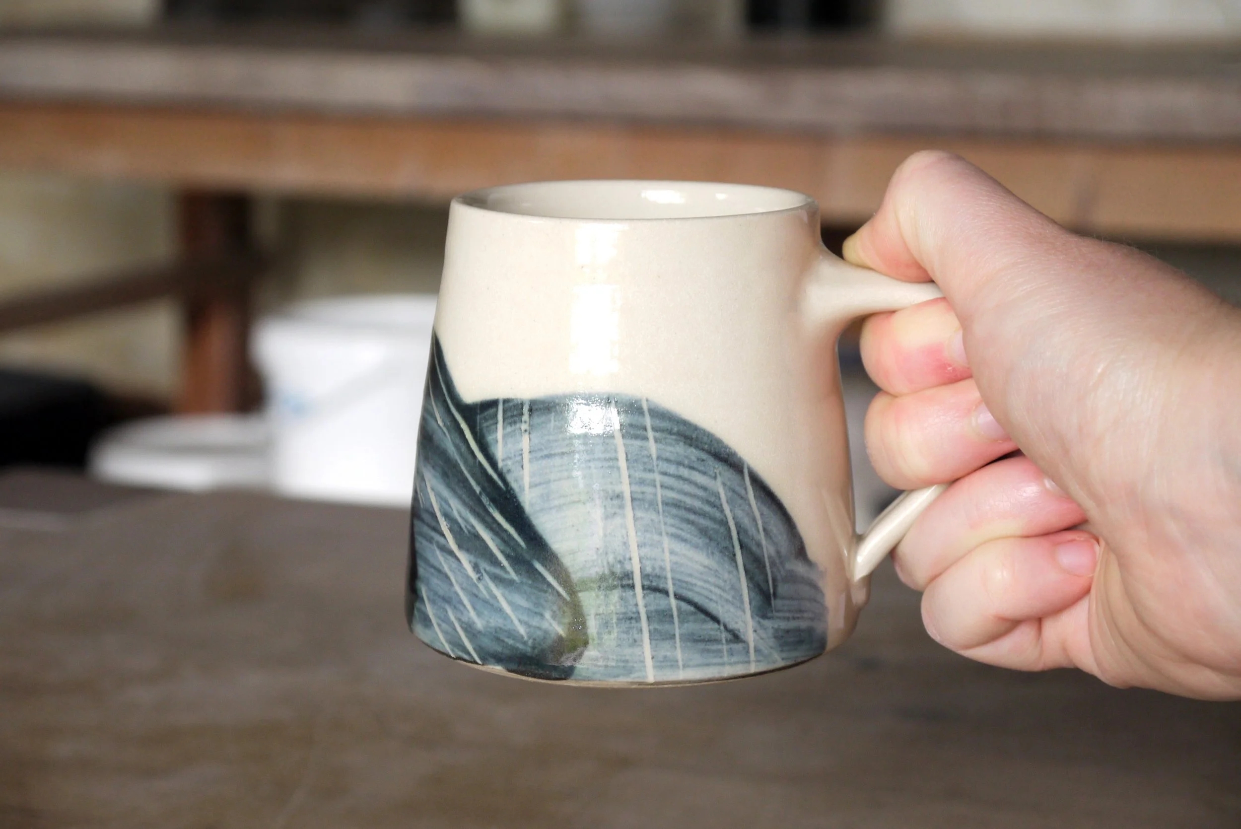 Fields tea mug in a hand.JPG