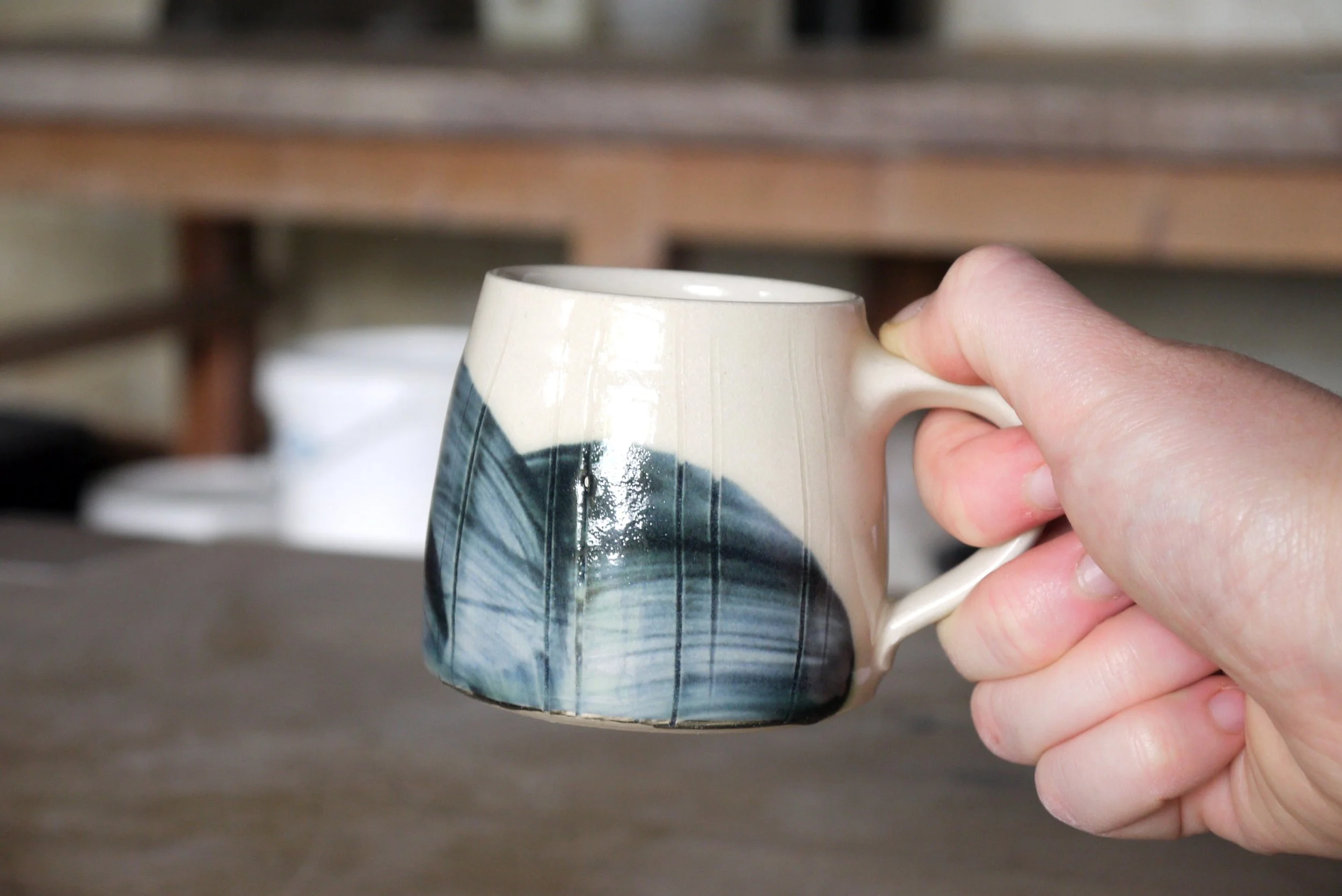 Fields coffee mug in a hand.JPG