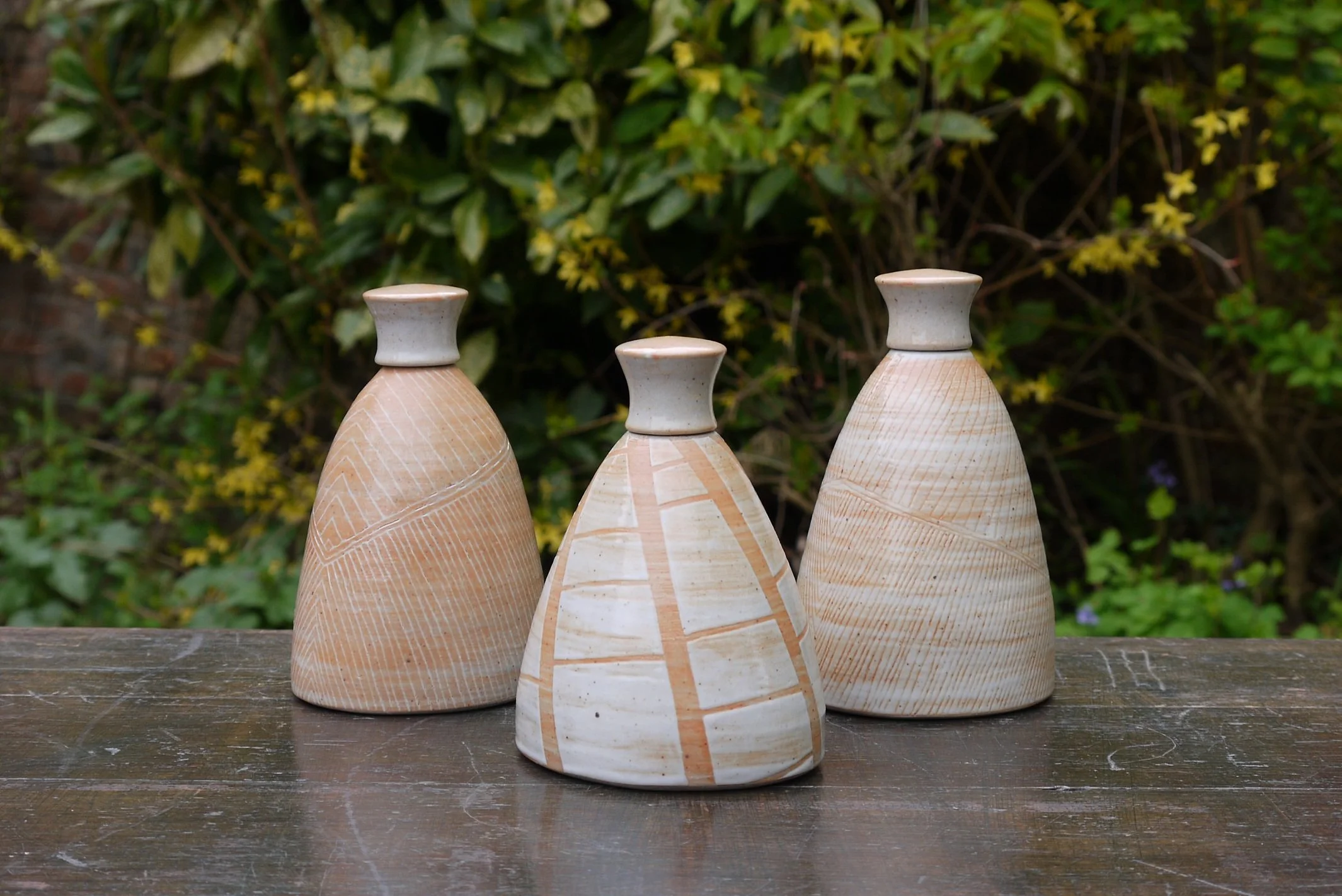 Collection of linear decorated shino lidded bottles.JPG