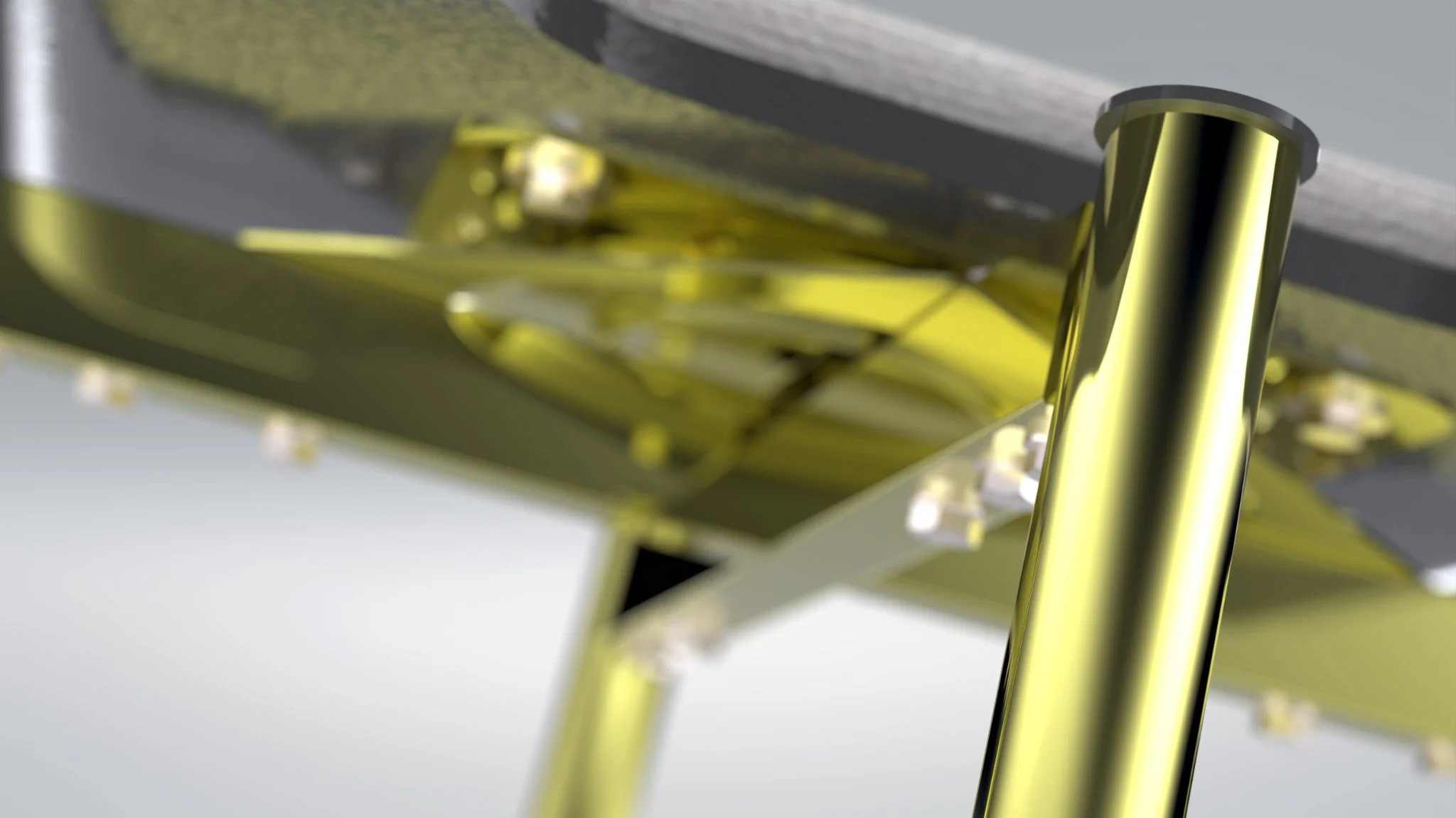 Detailed underside view of a metal chair assembly with gold-finished components.