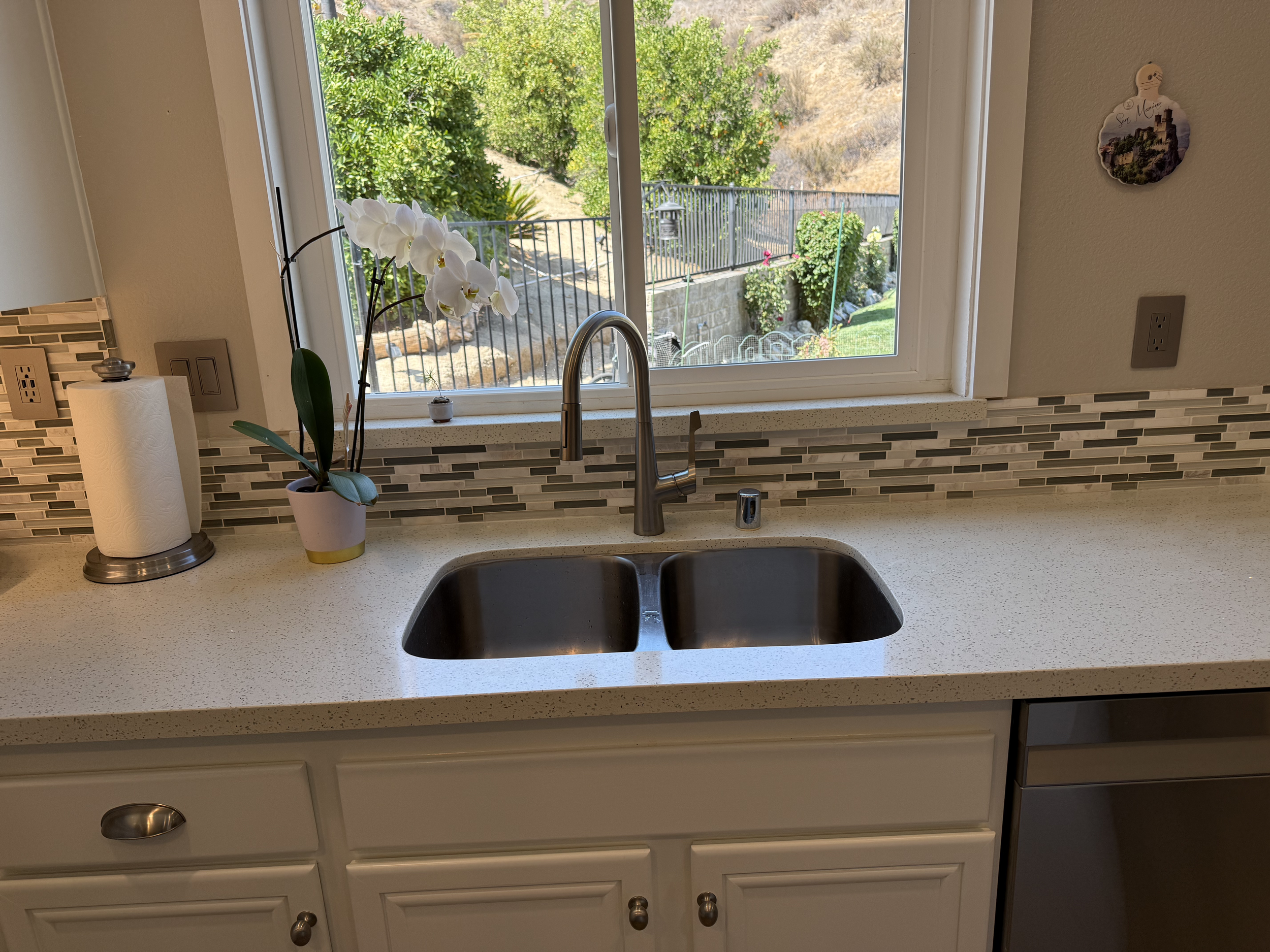 home for sale in Castaic California Los Angeles County with a white speckled countertop, mosaic tile backsplash