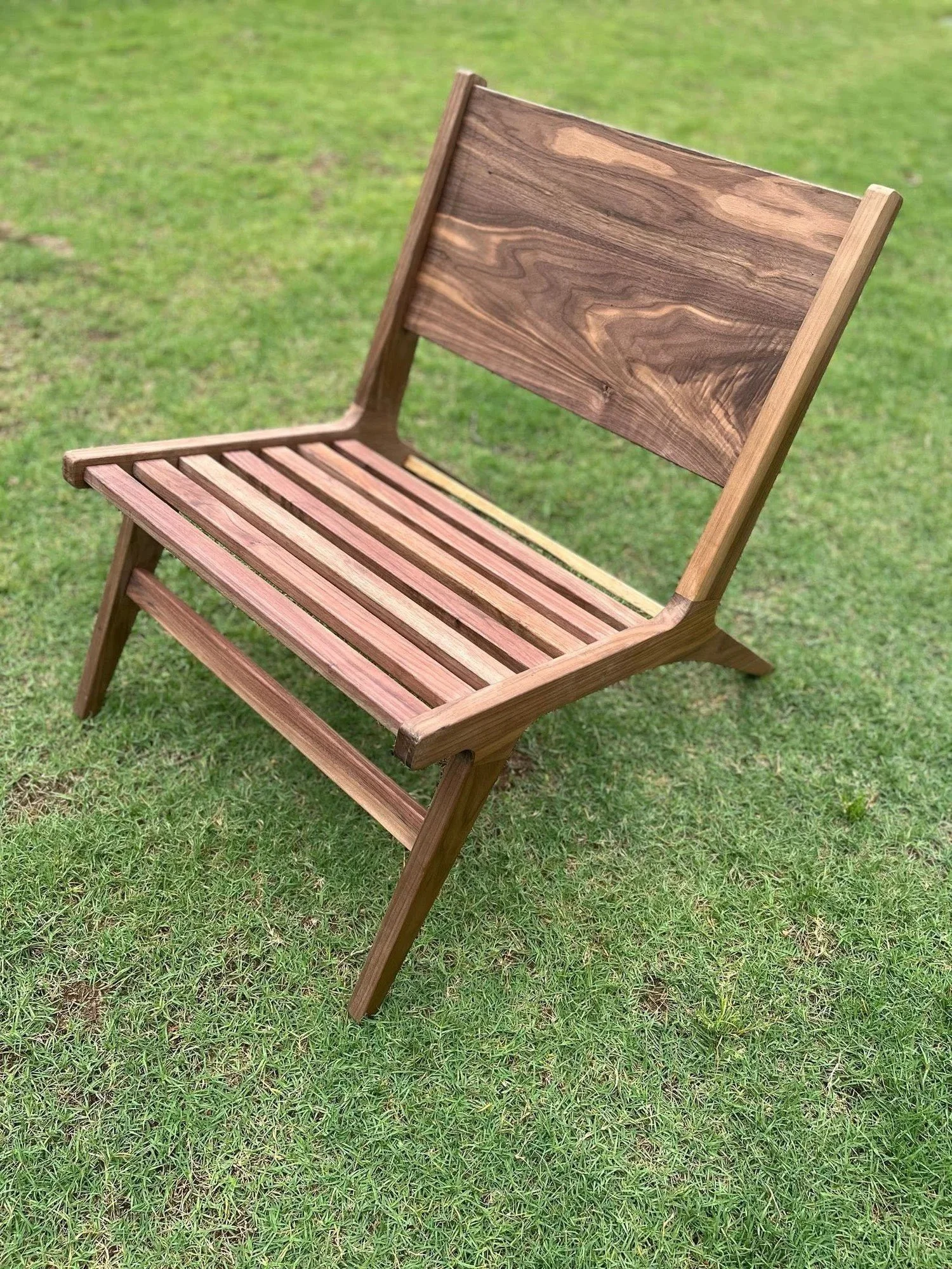 Handmade wooden lounge chair with a slatted seat and back