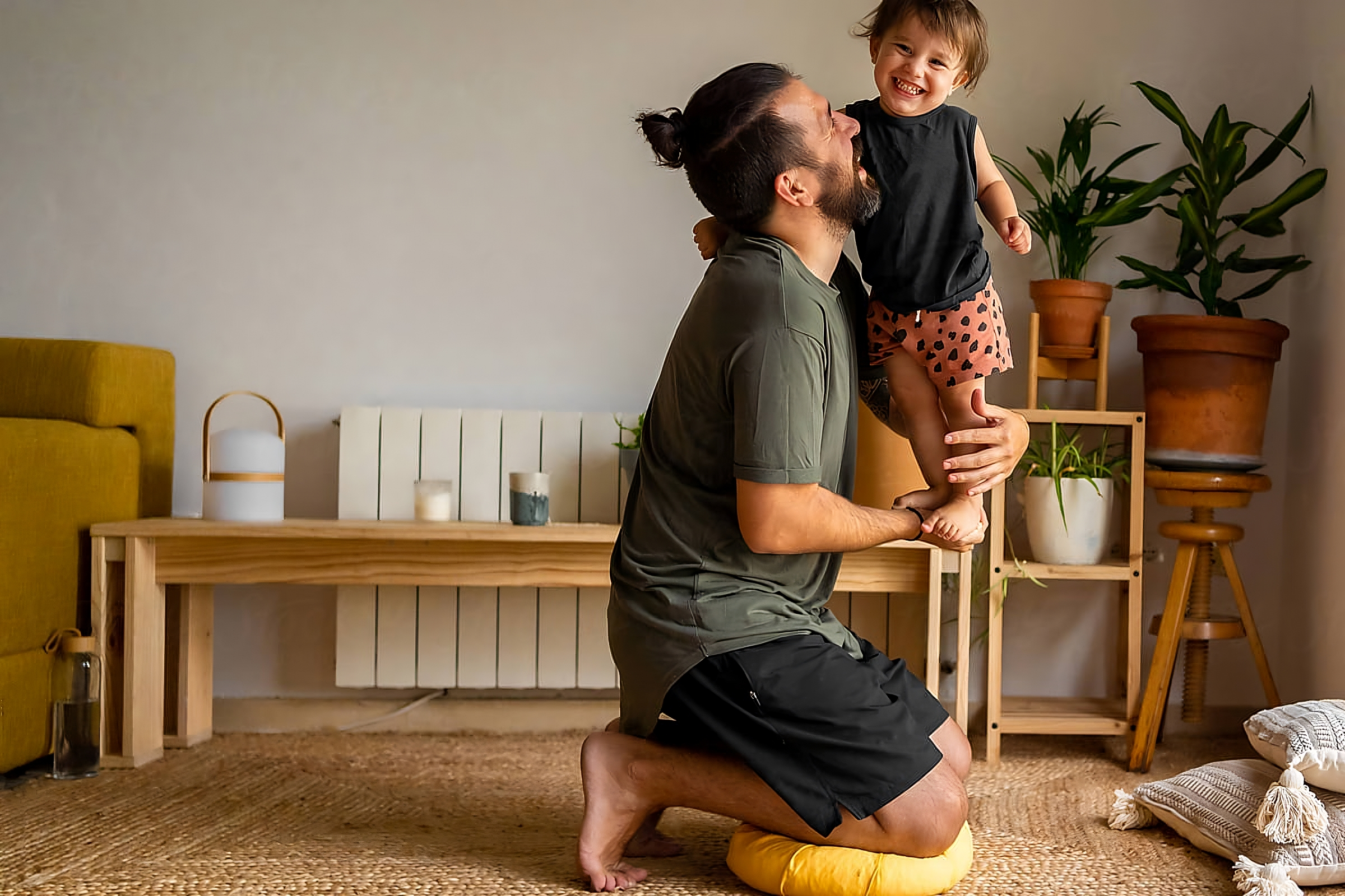 A relaxed man playing with his young son in a modern, comfortable and energy efficient home.