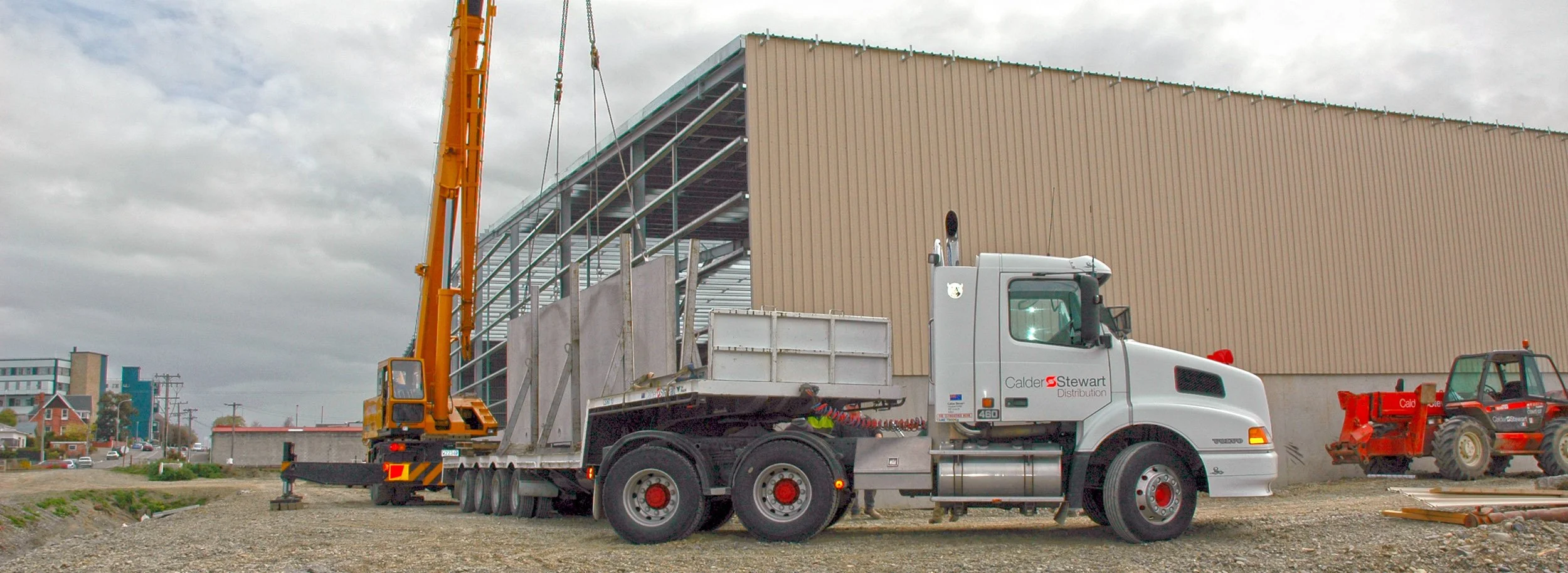 Construction site with a Volvo NH and a crane at work.