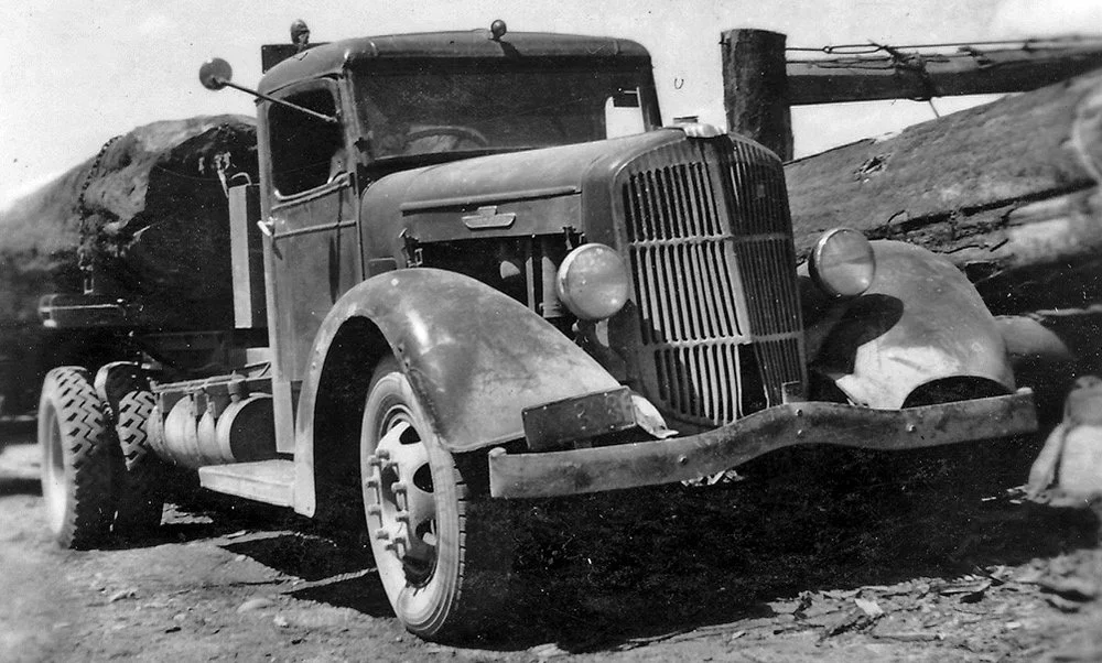 The REO unloading at a saw mill.