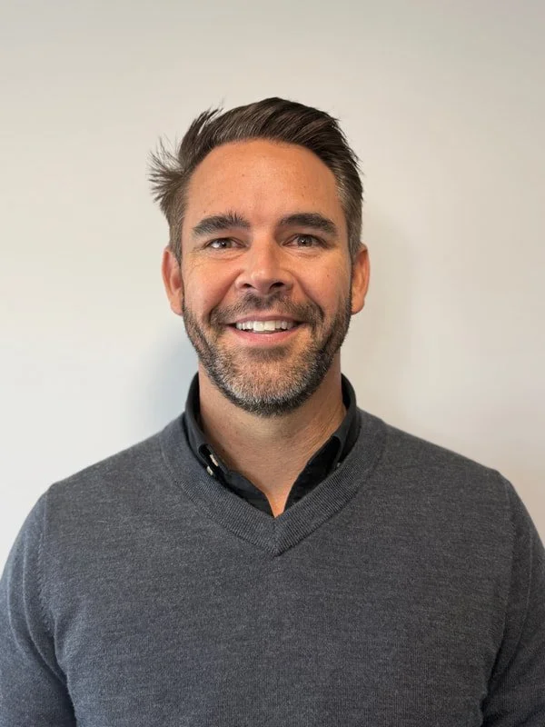 A man standing in front of a wall