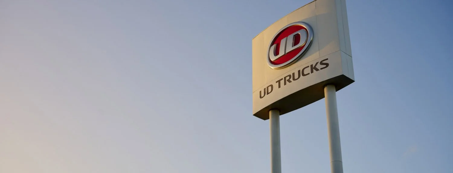 A UD trucks sign with blue sky in the background