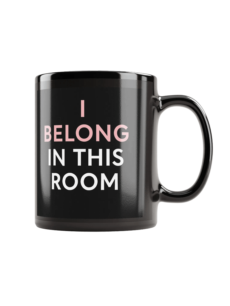 Black coffee mug with pink and white text that says, 'I BELONG IN THIS ROOM'.